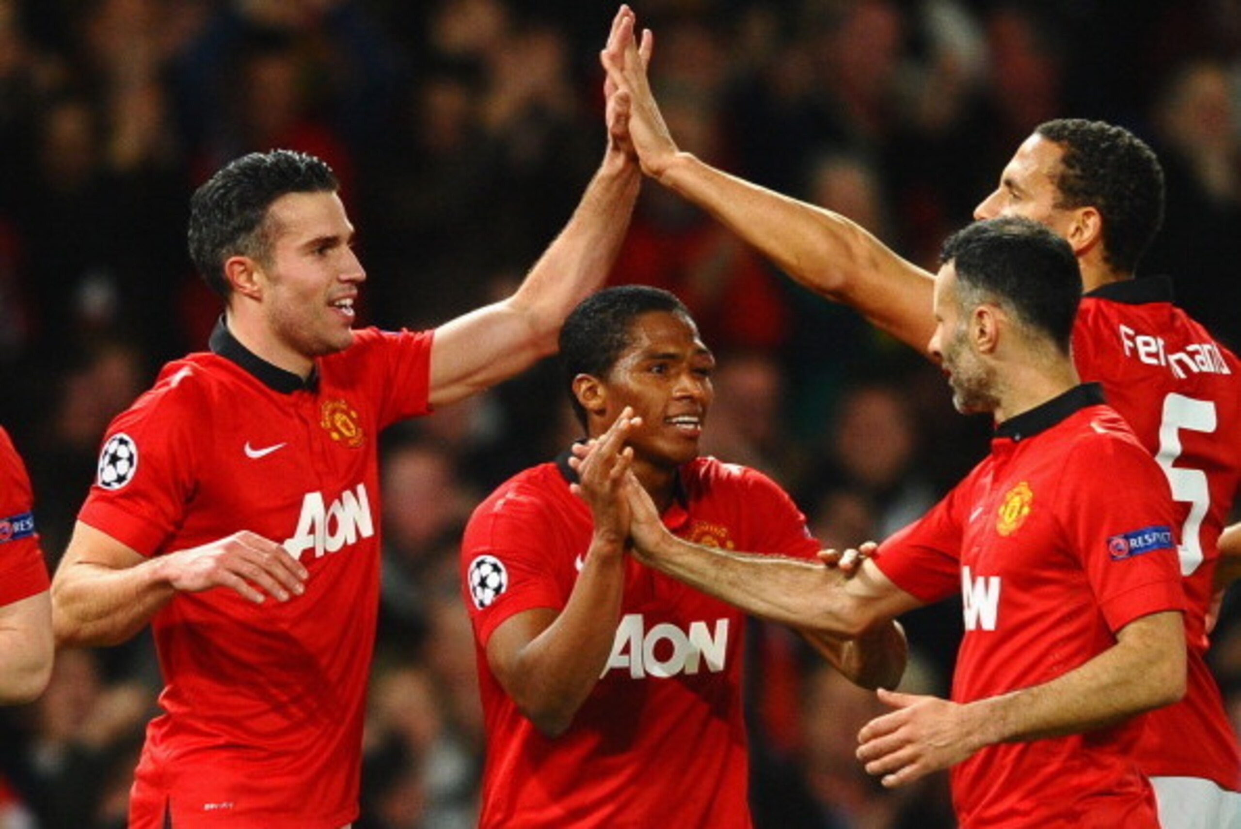 MANCHESTER, ENGLAND - MARCH 19:  Robin van Persie of Manchester United celebrates scoring the second goal with his team-mates during the UEFA Champions League Round of 16 second round match between Manchester United and Olympiacos FC at Old Trafford on Ma