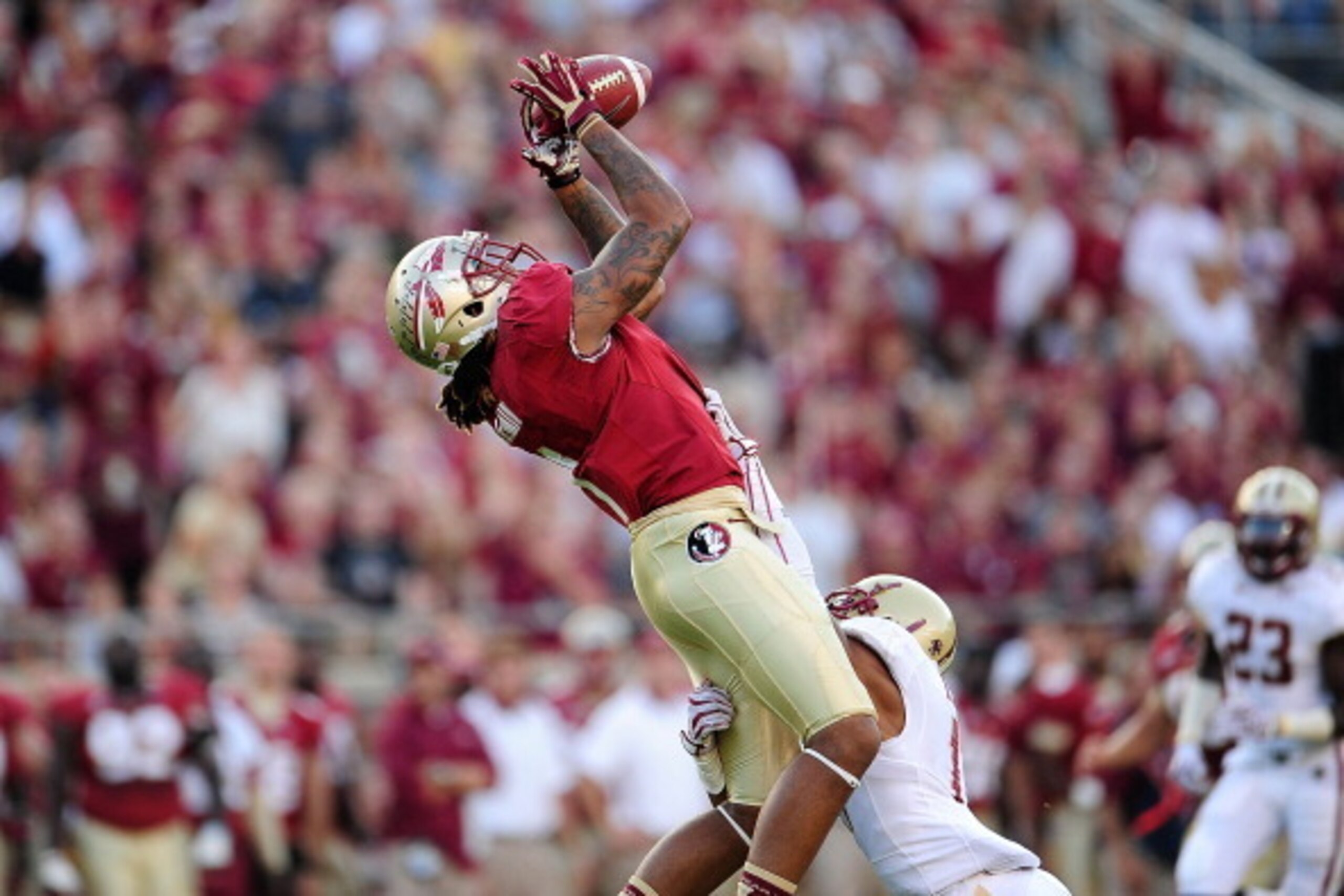 TALLAHASSEE, FL - OCTOBER 13:  Kelvin Benjamin #1 of the Florida State Seminoles catches a pass in front of Bryce Jones #17 of the Boston College Eagles during a game at Doak Campbell Stadium on October 13, 2012 in Tallahassee, Florida.  (Photo by Stacy R