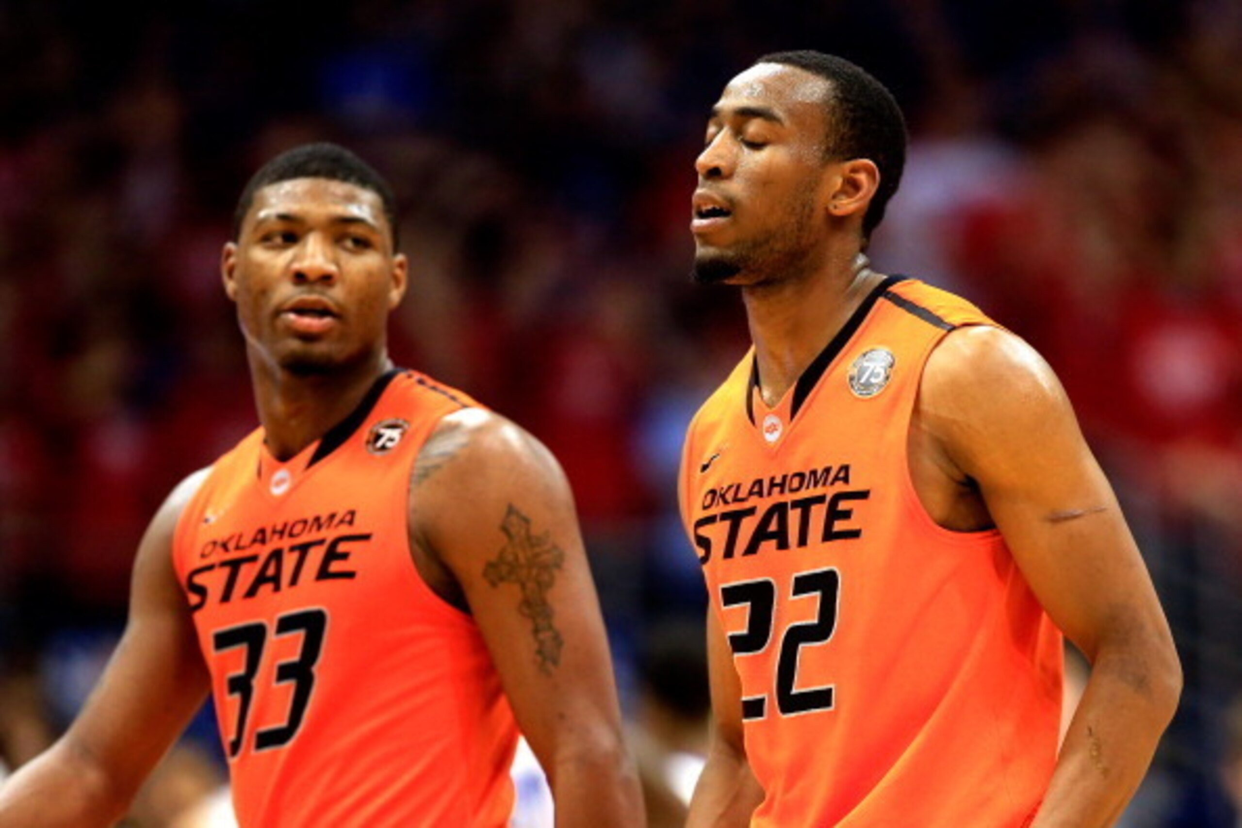 LAWRENCE, KS - JANUARY 18:  Marcus Smart #33 and Markel Brown #22 of the Oklahoma State Cowboys walk off the court during a timeout in the game against the Kansas Jayhawks at Allen Fieldhouse on January 18, 2014 in Lawrence, Kansas.  (Photo by Jamie Squir