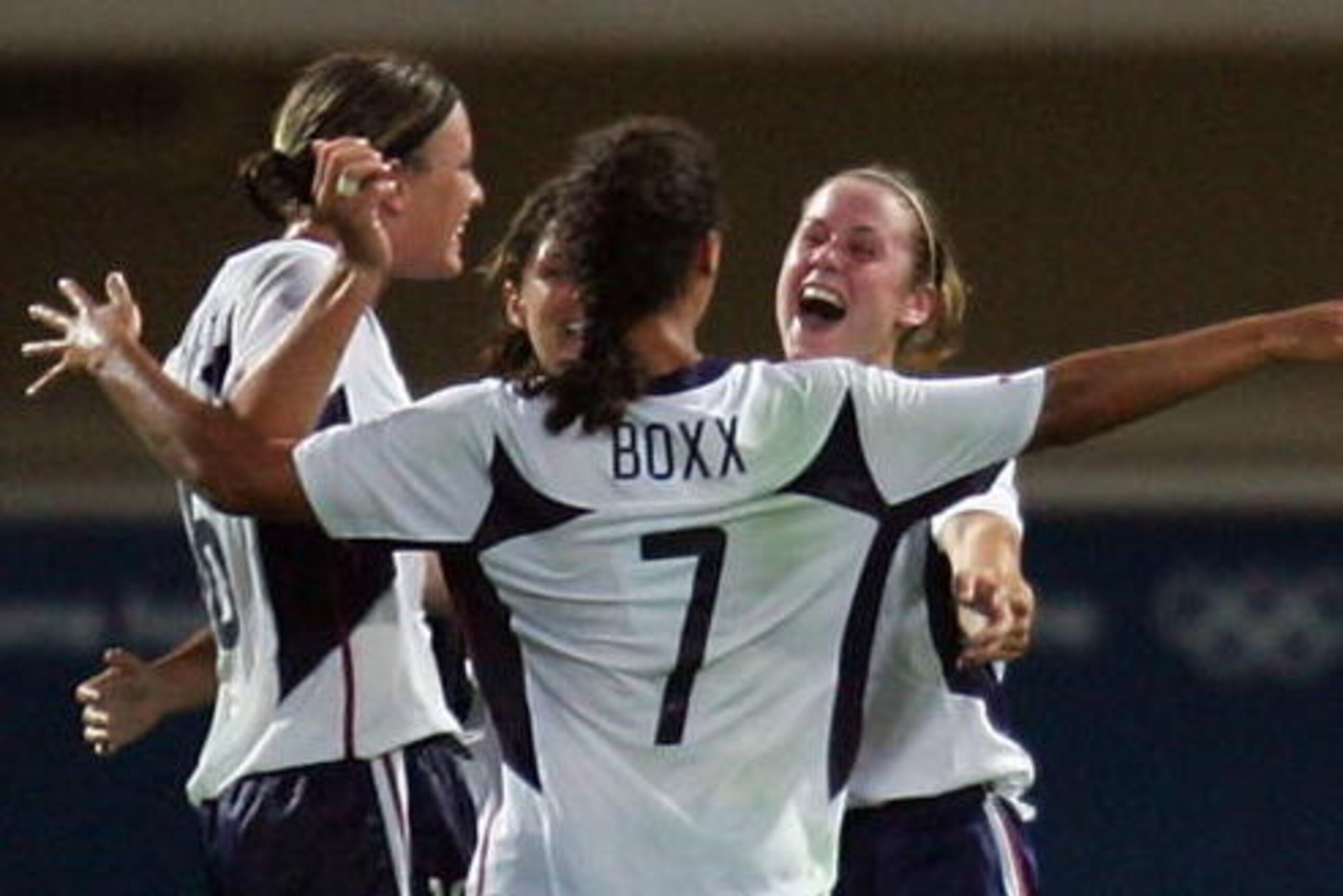 HERAKLIO, GREECE - AUGUST 23:  Heather O'Reilly (R) #17 is congratulated by her teammates including Shannon Boxx #7 after scoring USA's second and winning goal during the women's football semifinal match between USA and Germany on August 23, 2004 during t