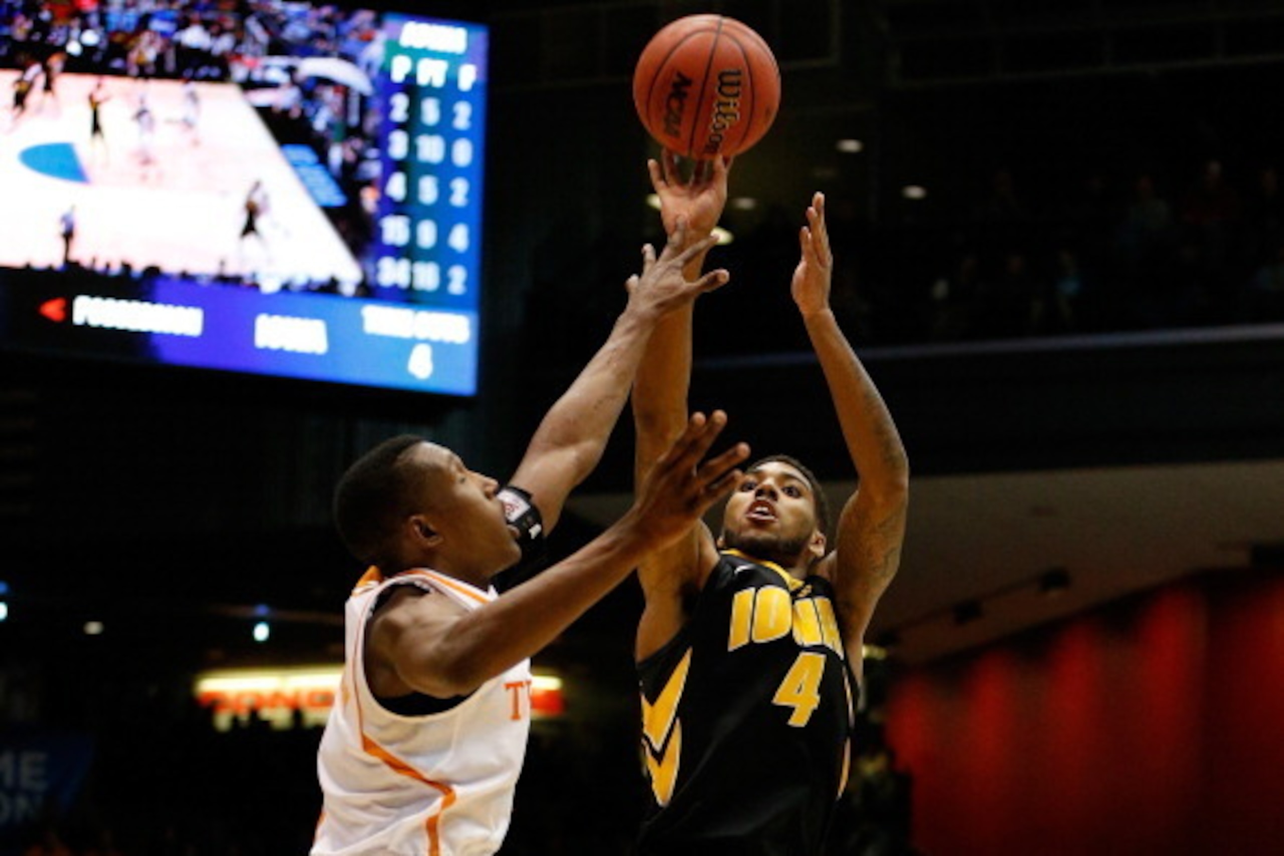 DAYTON, OH - MARCH 19:  Roy Devyn Marble #4 of the Iowa Hawkeyes takes a shot over Josh Richardson #1 of the Tennessee Volunteers during the first round of the 2014 NCAA Men's Basketball Tournament at UD Arena on March 19, 2014 in Dayton, Ohio.  (Photo by