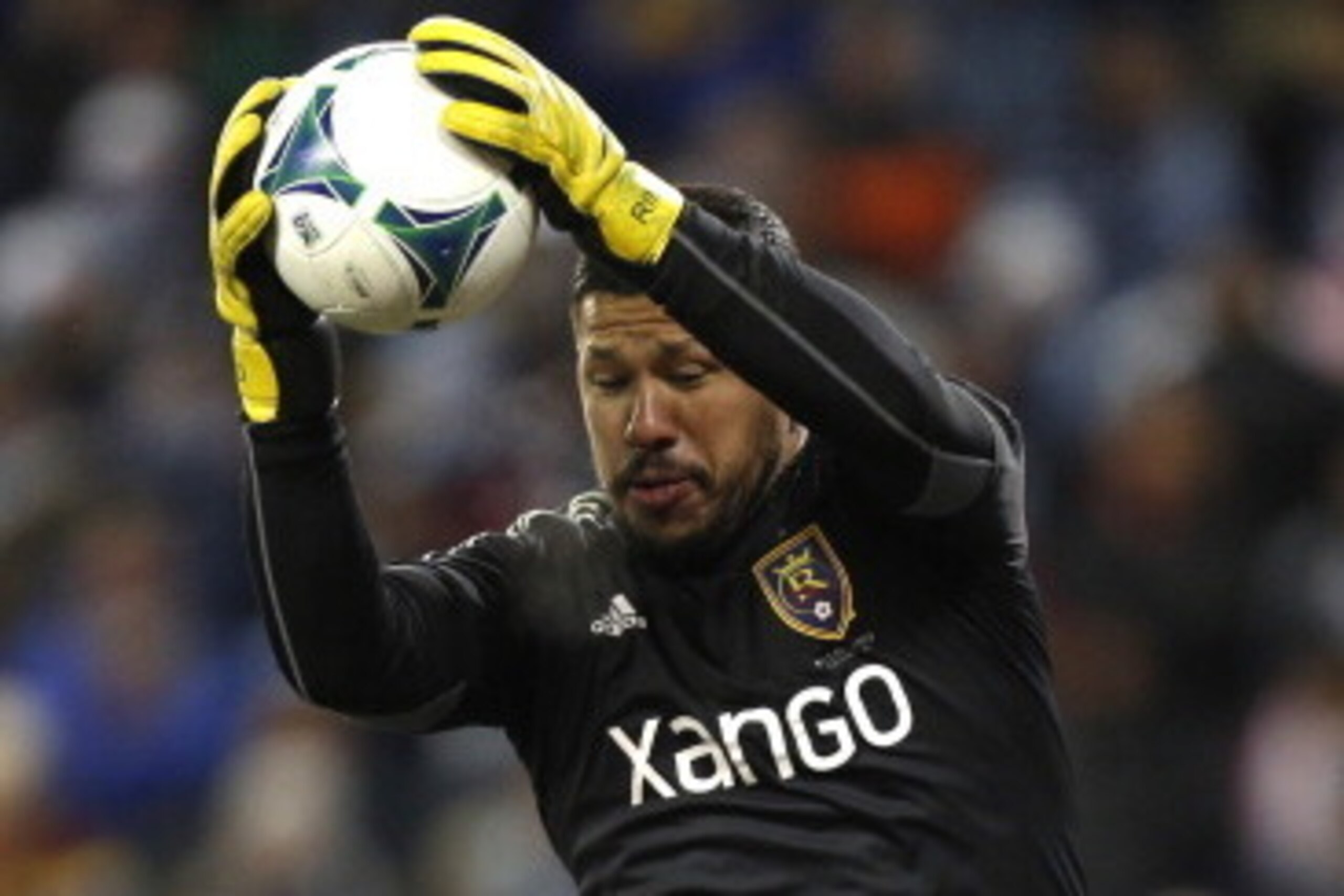KANSAS CITY, KS - DECEMBER 7:  Nick Rimando #18 of Real Salt Lake jumps behind Nat Borchers #6 as he catches the ball on a corner kick in the in the MLS Cup Final against the Sporting Kansas City at Sporting Park on December 7, 2013 in Kansas City, Kansas