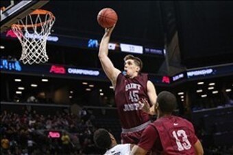 Mar 16, 2014; Brooklyn, NY, USA; Saint Joseph's Hawks forward Halil Kanacevic (45) fouls on his way to the basket during the second half against the Virginia Commonwealth Rams in the championship game for the Atlantic 10 Conference college basketball tour