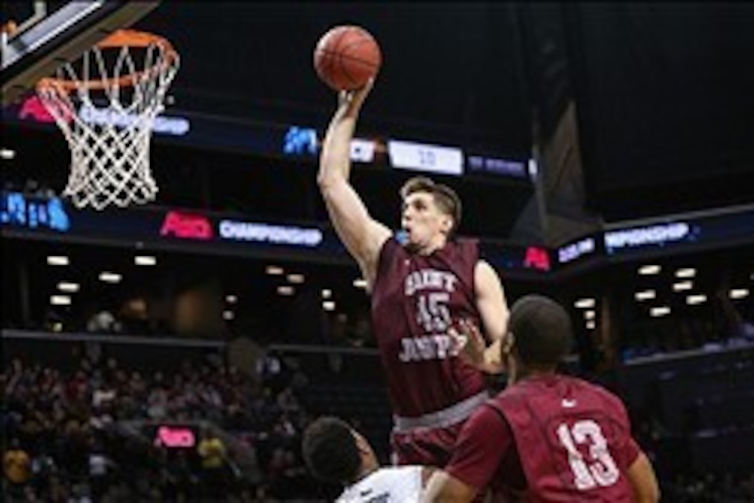 Mar 16, 2014; Brooklyn, NY, USA; Saint Joseph's Hawks forward Halil Kanacevic (45) fouls on his way to the basket during the second half against the Virginia Commonwealth Rams in the championship game for the Atlantic 10 Conference college basketball tour