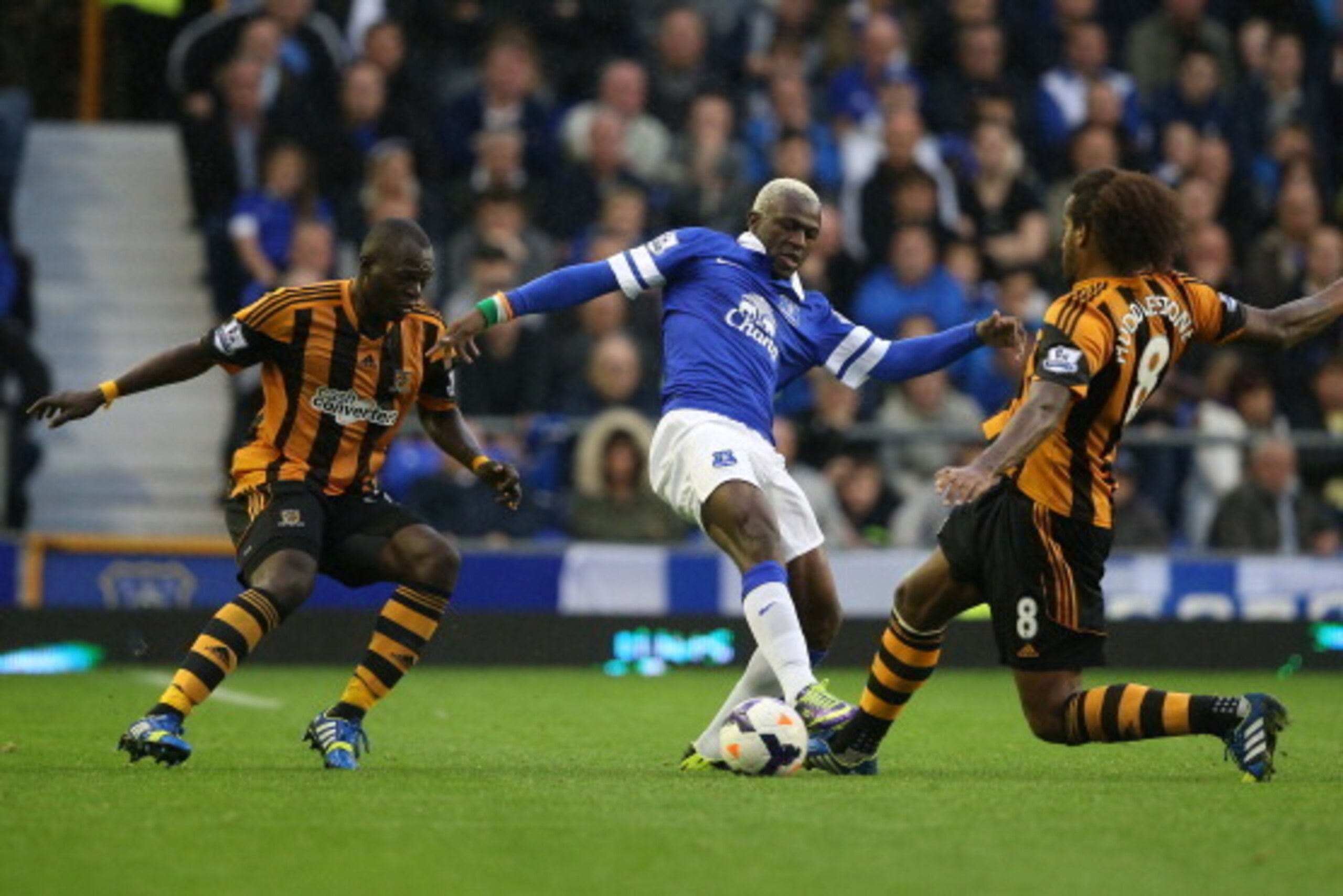 LIVERPOOL, ENGLAND - OCTOBER 19:  Arouna Kone of Everton is challenged by Tom Huddlestone of Hull City during the Barclays Premier League match between Everton and Hull City at Goodison Park on October 19, 2013 in Liverpool, England.  (Photo by Clive Brun