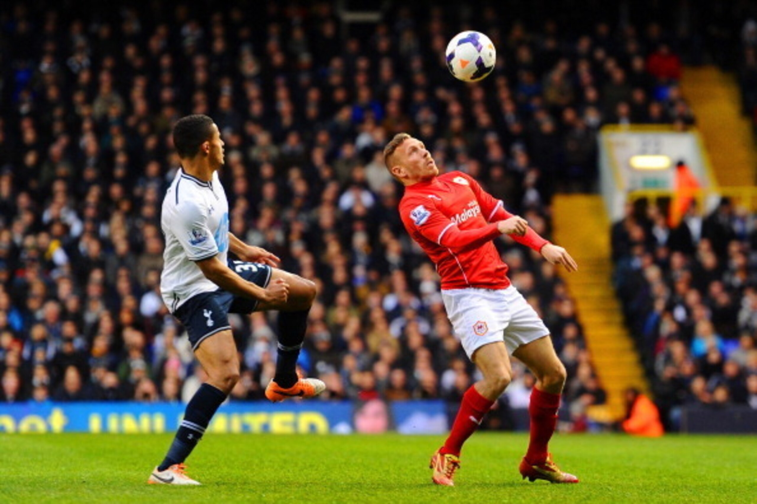 LONDON, ENGLAND - MARCH 02: Craig Bellamy of Cardiff City controls the ball under the watchful eye of Ezekiel Fryers of Tottenham Hotspur during the Barclays Premier League match between Tottenham Hotspur and Cardiff City at White Hart Lane on March 2, 20