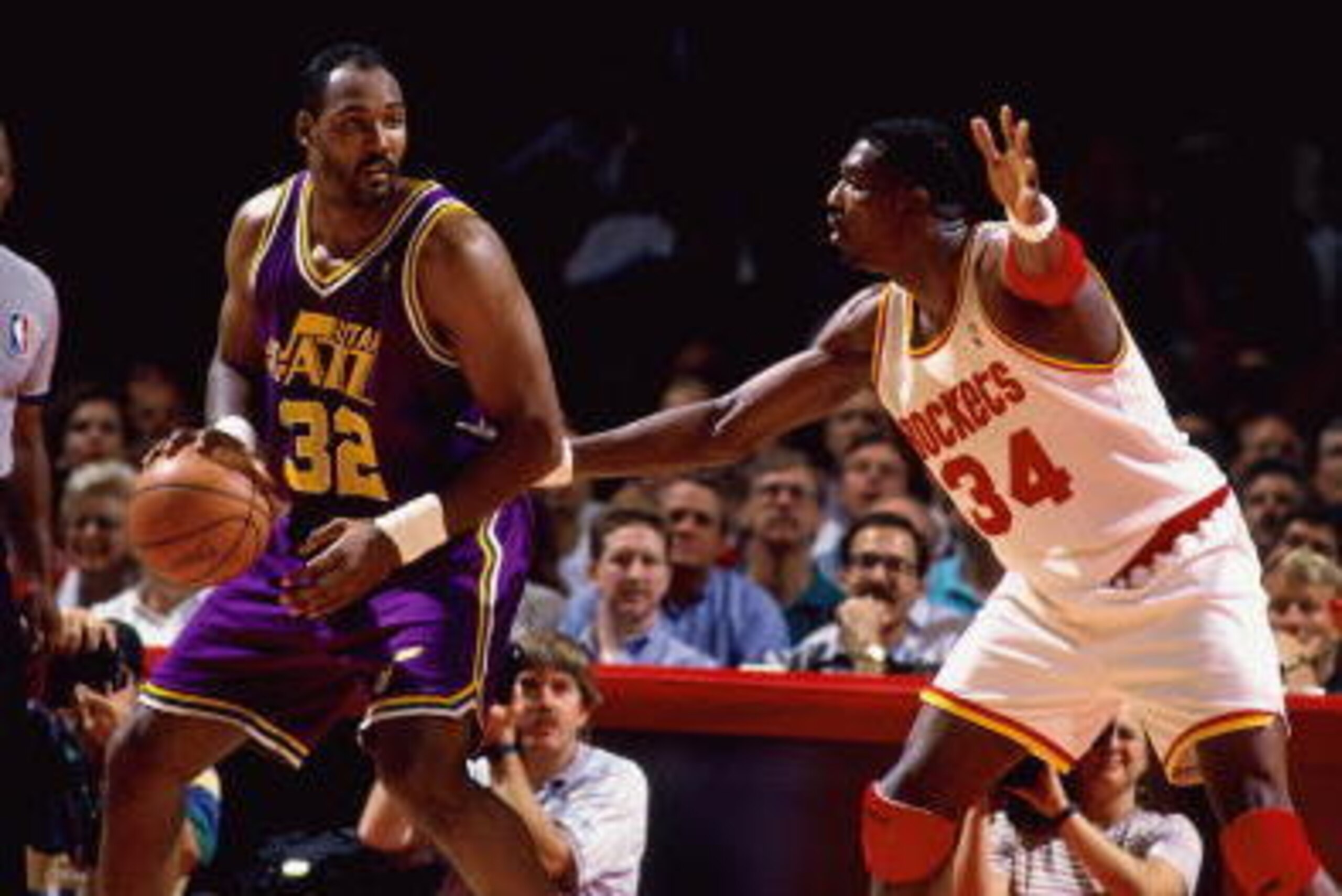HOUSTON - MAY 25:  Karl Malone #32 of the Utah Jazz posts up against Hakeem Olajuwon #34 of the Houston Rockets during Game Two of the Western Conference Finals played on May 25, 1994 at the Summitt in Houston, Texas. Houston defeated Utah 104-99 and won 