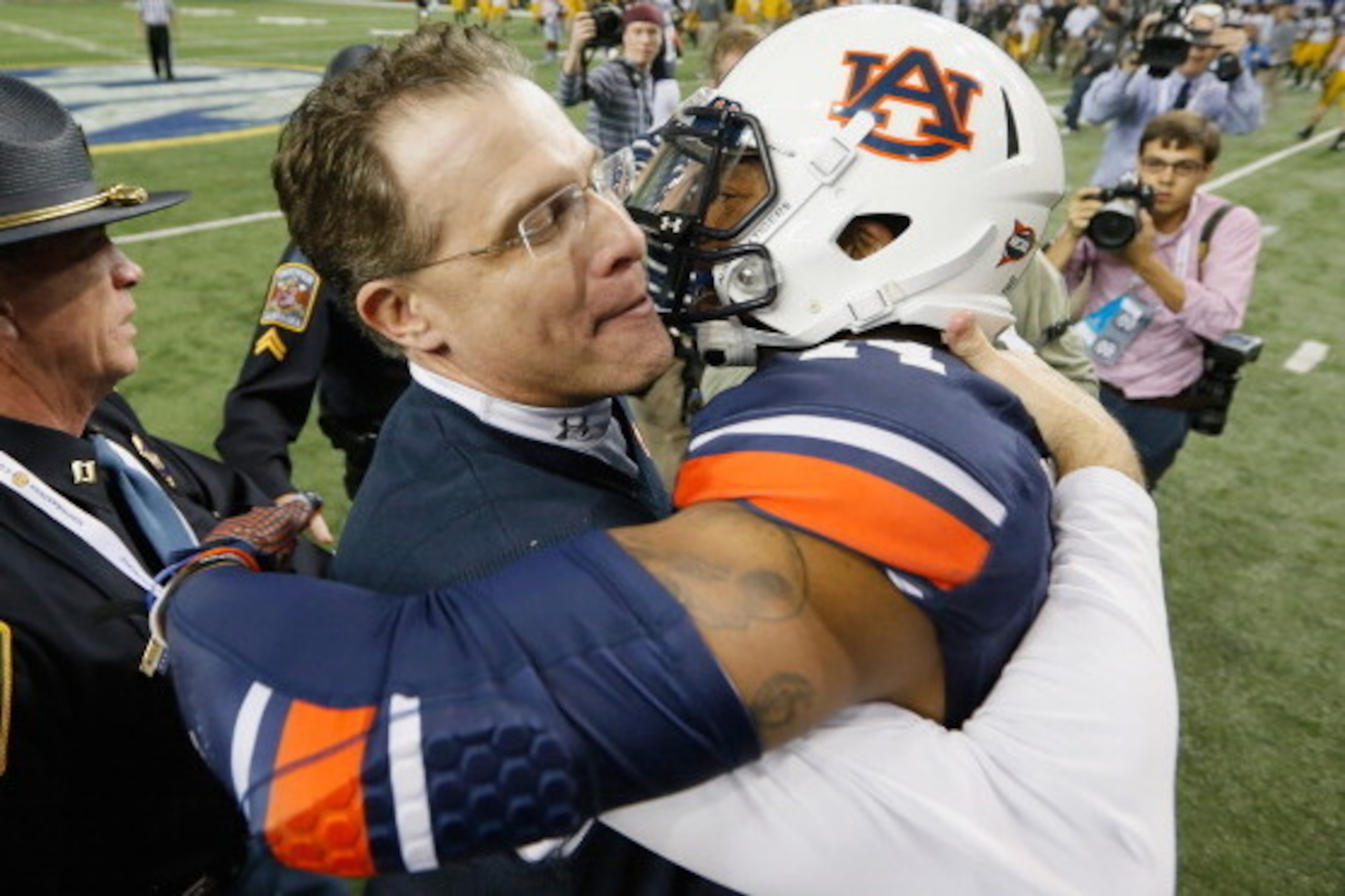 ATLANTA, GA - DECEMBER 07:  Head coach Gus Malzahn of the Auburn Tigers hugs quarterback Nick Marshall #14 of the Auburn Tigers in celebration of their 59-42 win over the Missouri Tigers 59-42 to win the SEC Championship Game at Georgia Dome on December 7