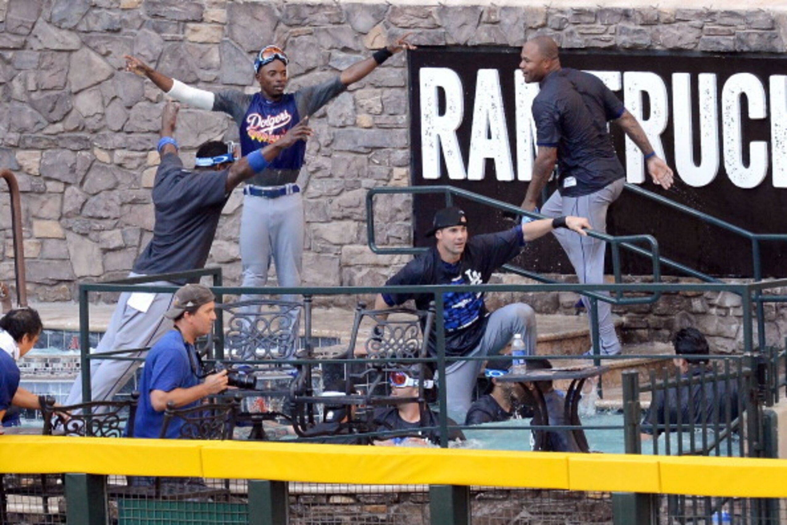 PHOENIX, AZ - SEPTEMBER 19:  Los Angeles Dodgers players jump in the pool after clinching the National League West after a 7-6 win against the Arizona Diamondbacks at Chase Field on September 19, 2013 in Phoenix, Arizona.  (Photo by Norm Hall/Getty Images