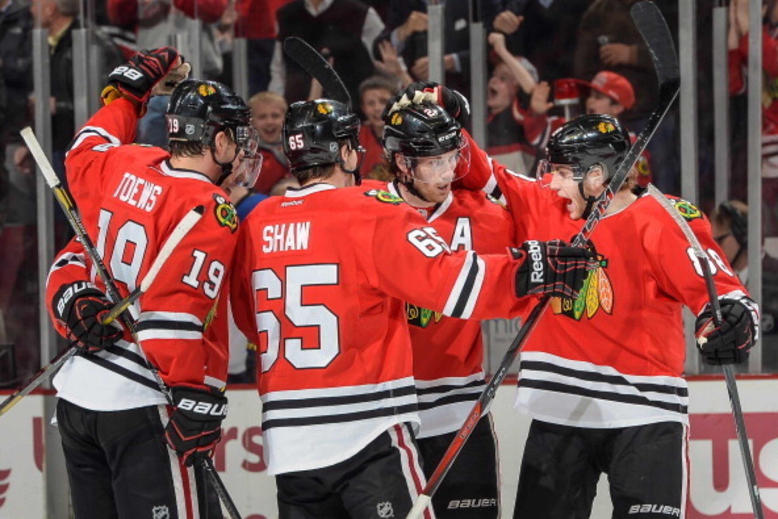 CHICAGO, IL - MARCH 19: Duncan Keith #2 (C) of the Chicago Blackhawks celebrates with teammates including Patrick Kane #88 after scoring against the St. Louis Blues during the NHL game on March 19, 2014 at the United Center in Chicago, Illinois. (Photo by