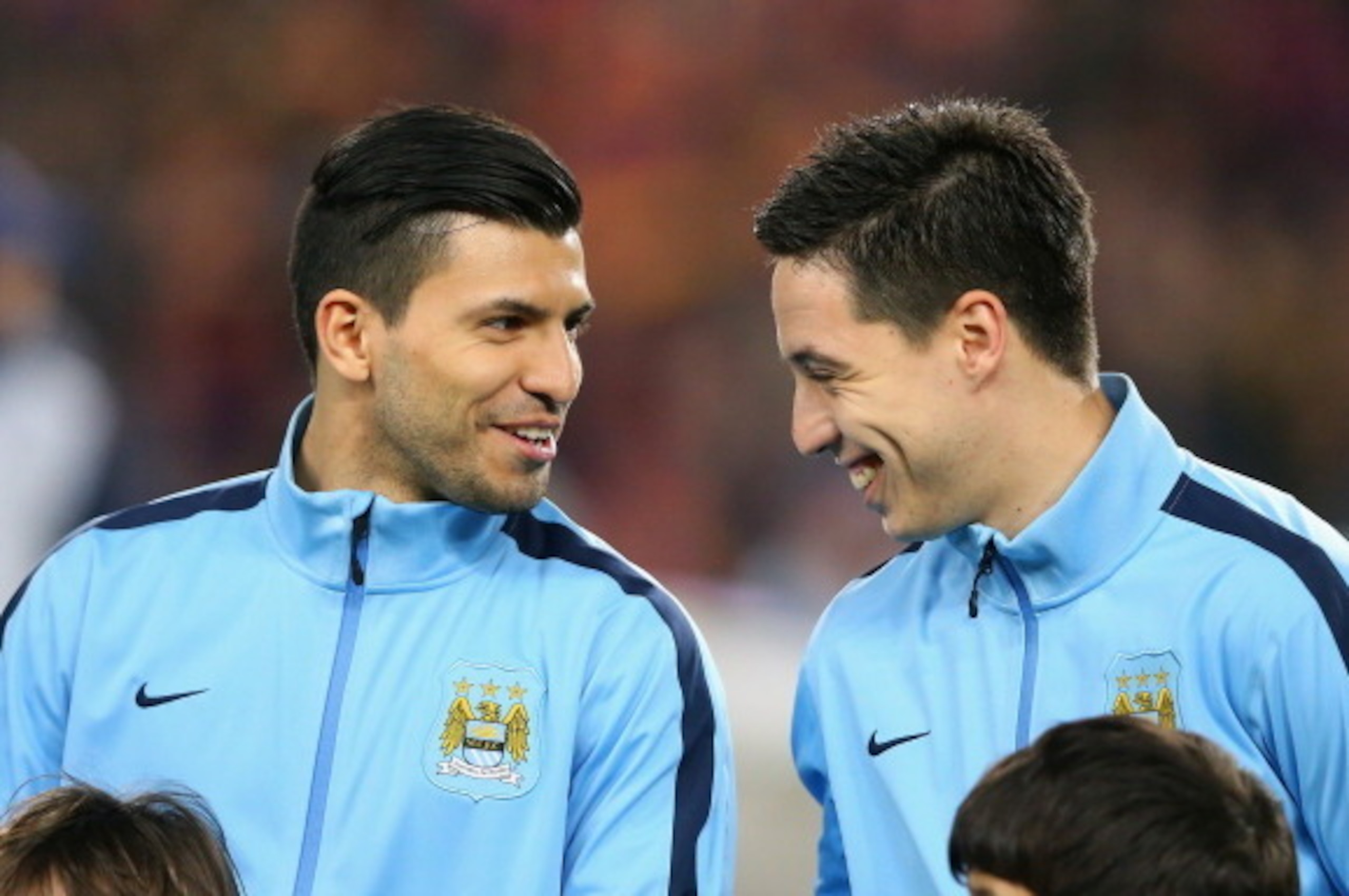 BARCELONA, SPAIN - MARCH 12:  Sergio Aguero and Samir Nasri of Manchester City share a joke prior to the UEFA Champions League Round of 16 match between FC Barcelona and Manchester City at Camp Nou on March 12, 2014 in Barcelona, Spain.  (Photo by Alex Li