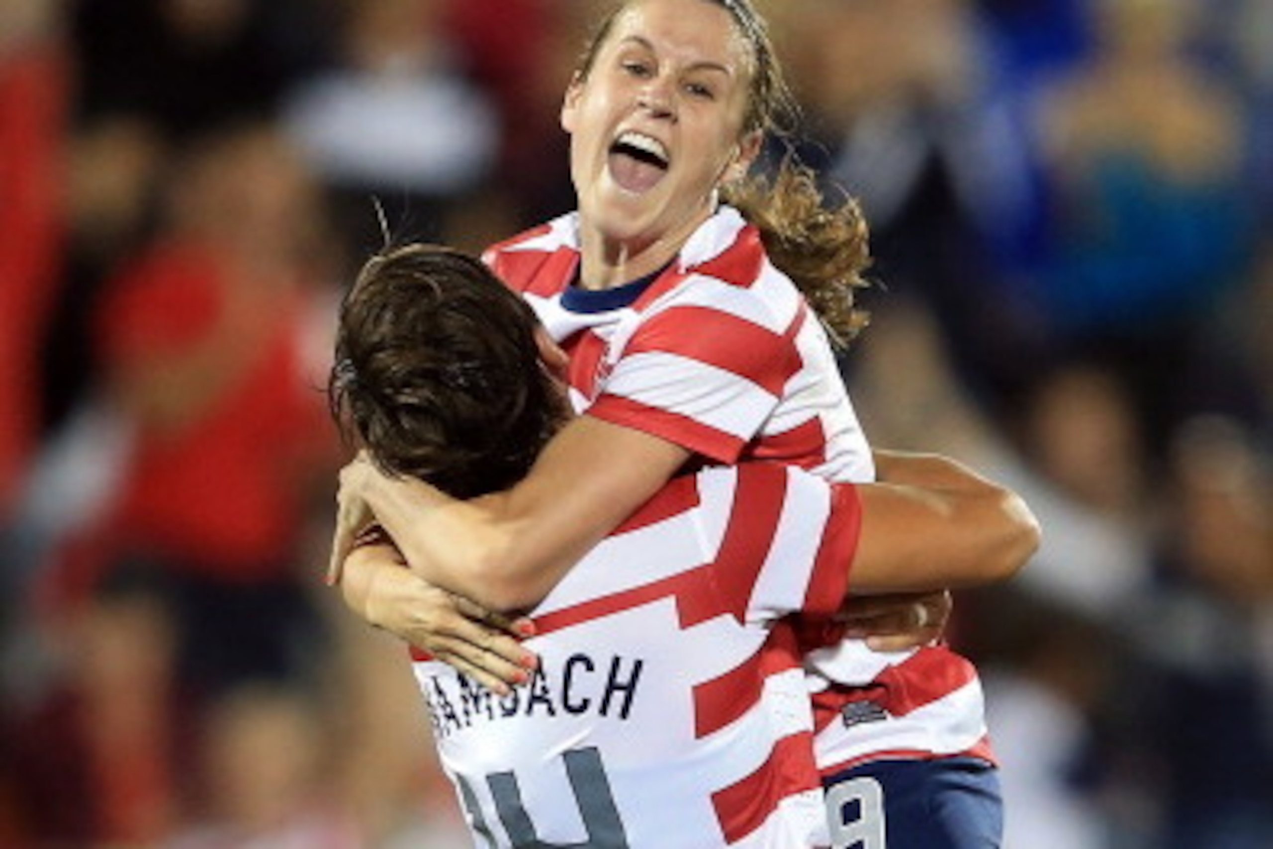 COMMERCE CITY, CO - SEPTEMBER 19:  Heather O'Reilly #9 of the USA jumps intto the arms of Abby Wambach #14 of the USA as she celebrates her goal against Australia at Dick's Sporting Goods Park on September 19, 2012 in Commerce City, Colorado. The USA defe