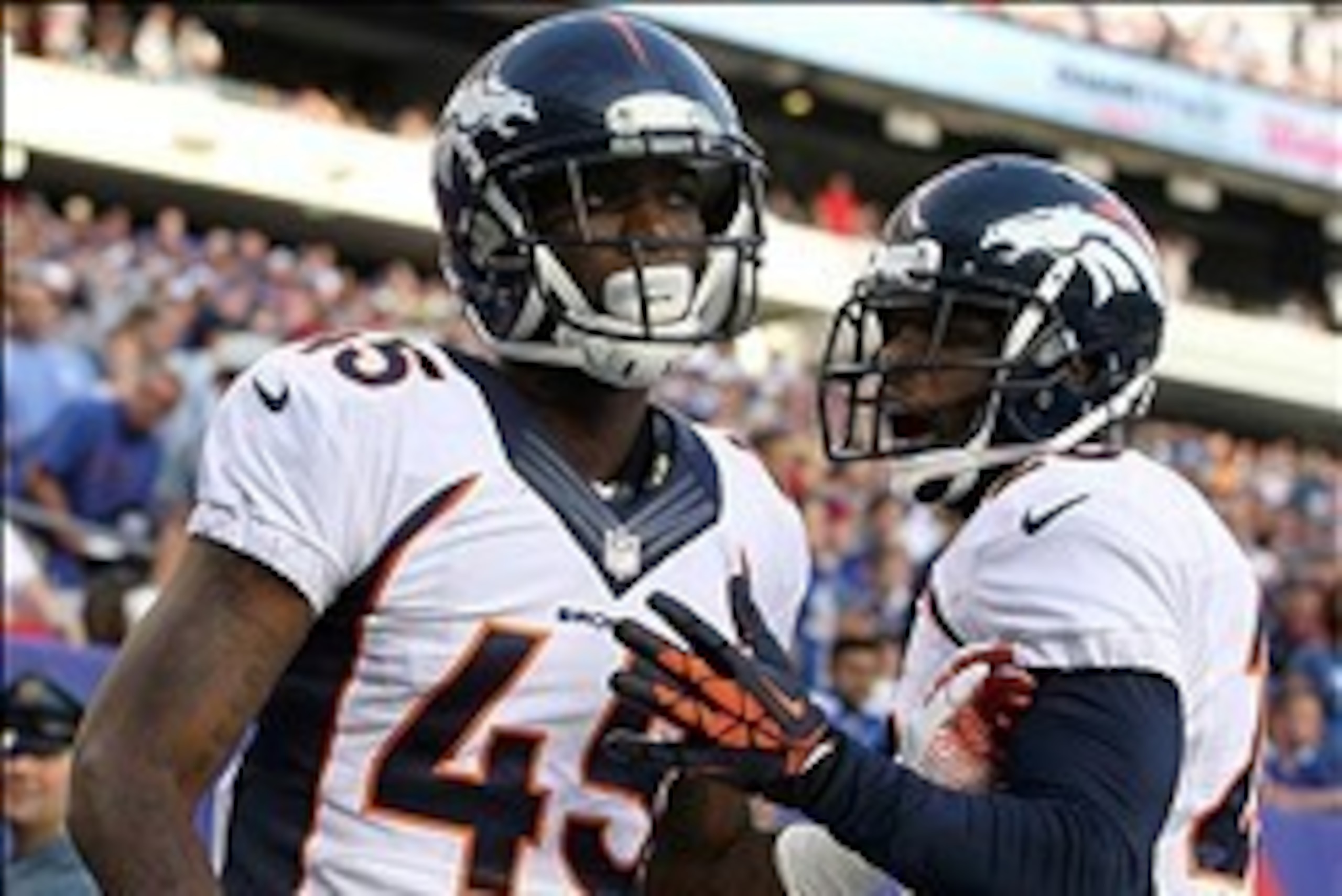 Sep 15, 2013; East Rutherford, NJ, USA; Denver Broncos corner back Dominique Rodgers-Cromartie (45) celebrates his interception against the New York Giants with Denver Broncos safety Mike Adams (20) during the second quarter of a game at MetLife Stadium. 