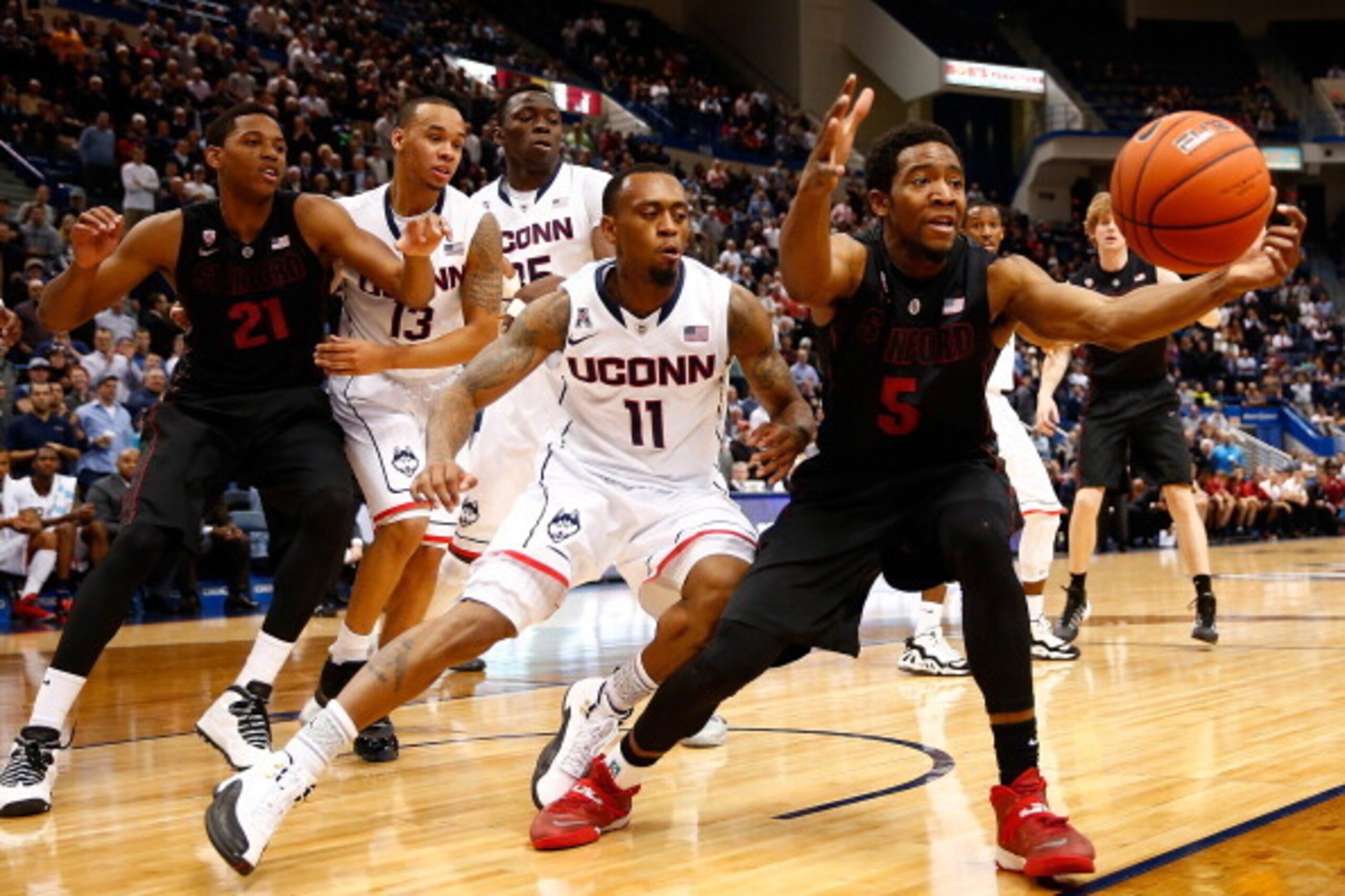 HARTFORD, CT - DECEMBER 18: Chasson Randle #5 of the Stanford Cardinal grabs a loose ball in front of Ryan Boatright #11 of the Connecticut Huskies in the first half during the game at XL Center on December 18, 2013 in Hartford, Connecticut.  (Photo by Ja