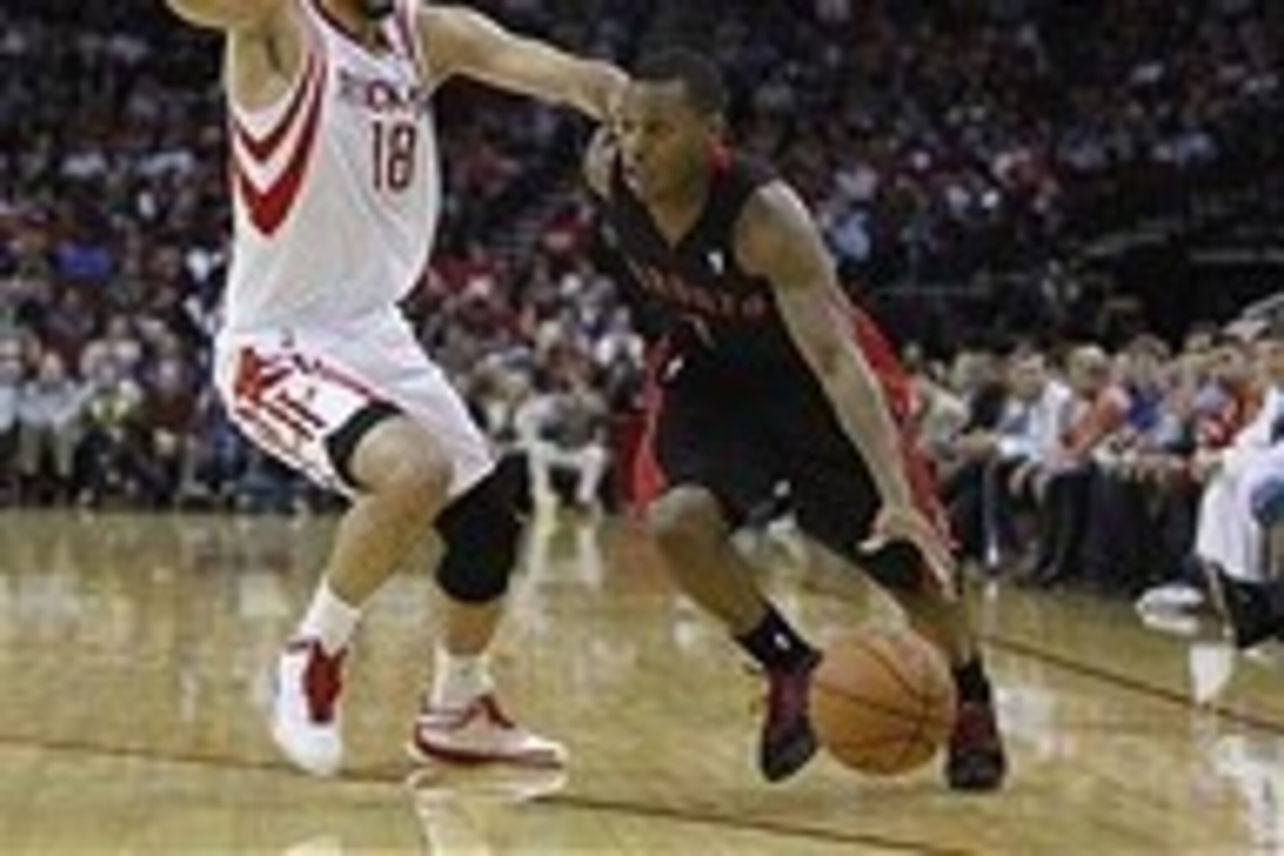 Nov 11, 2013; Houston, TX, USA; Toronto Raptors point guard Kyle Lowry (7) dribbles the ball around Houston Rockets small forward Omri Casspi (18) during the third quarter at Toyota Center. The Rockets won 110-104. Mandatory Credit: Andrew Richardson-USA 