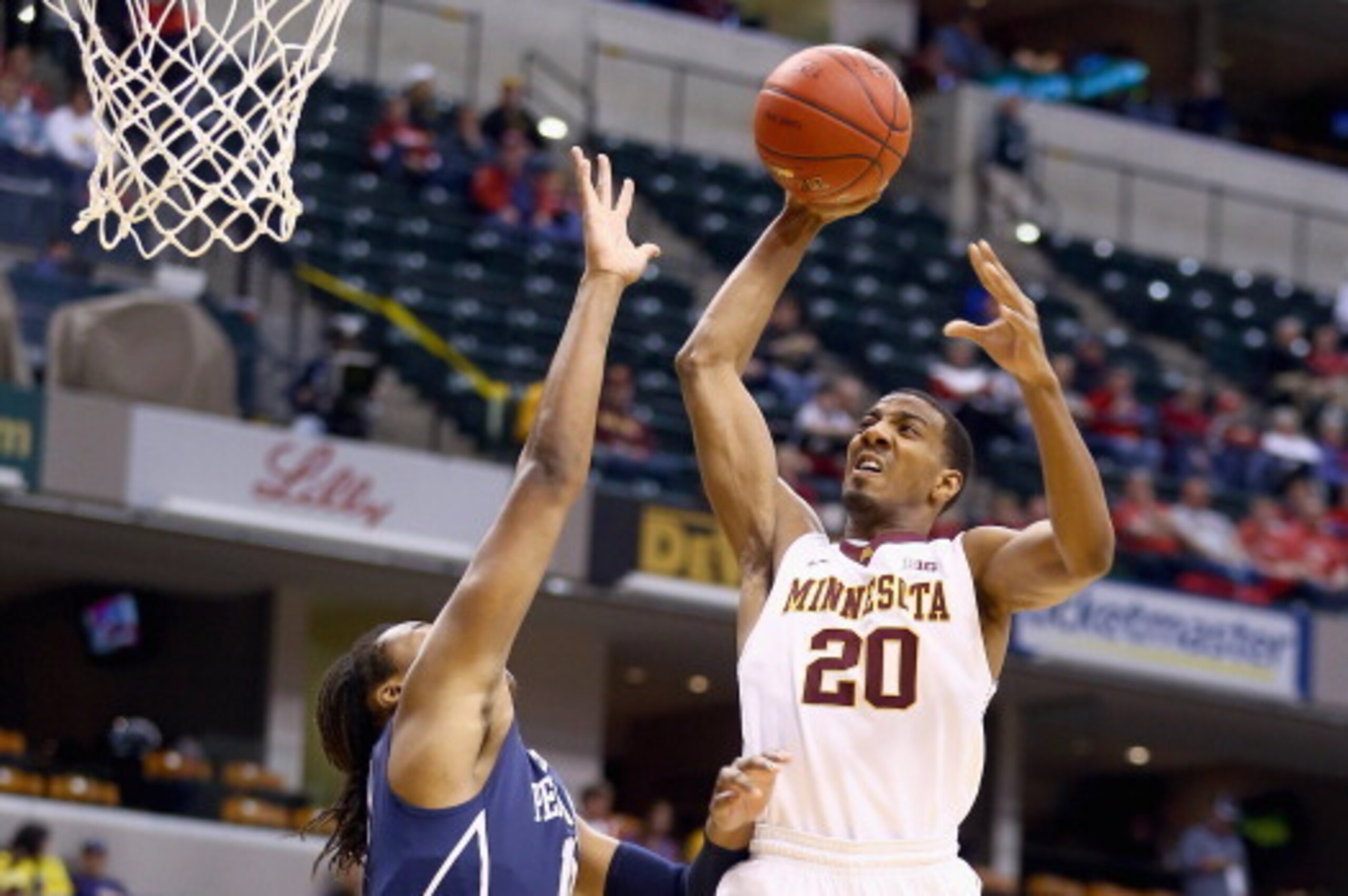 INDIANAPOLIS, IN - MARCH 13:  Austin Hollins #20 of the Minnesota Golden Gophers shoots the ball in the game against the Penn State  Nittany Lions during the first round of the Big Ten Basketball Tournament at Bankers Life Fieldhouse on March 13, 2014 in 