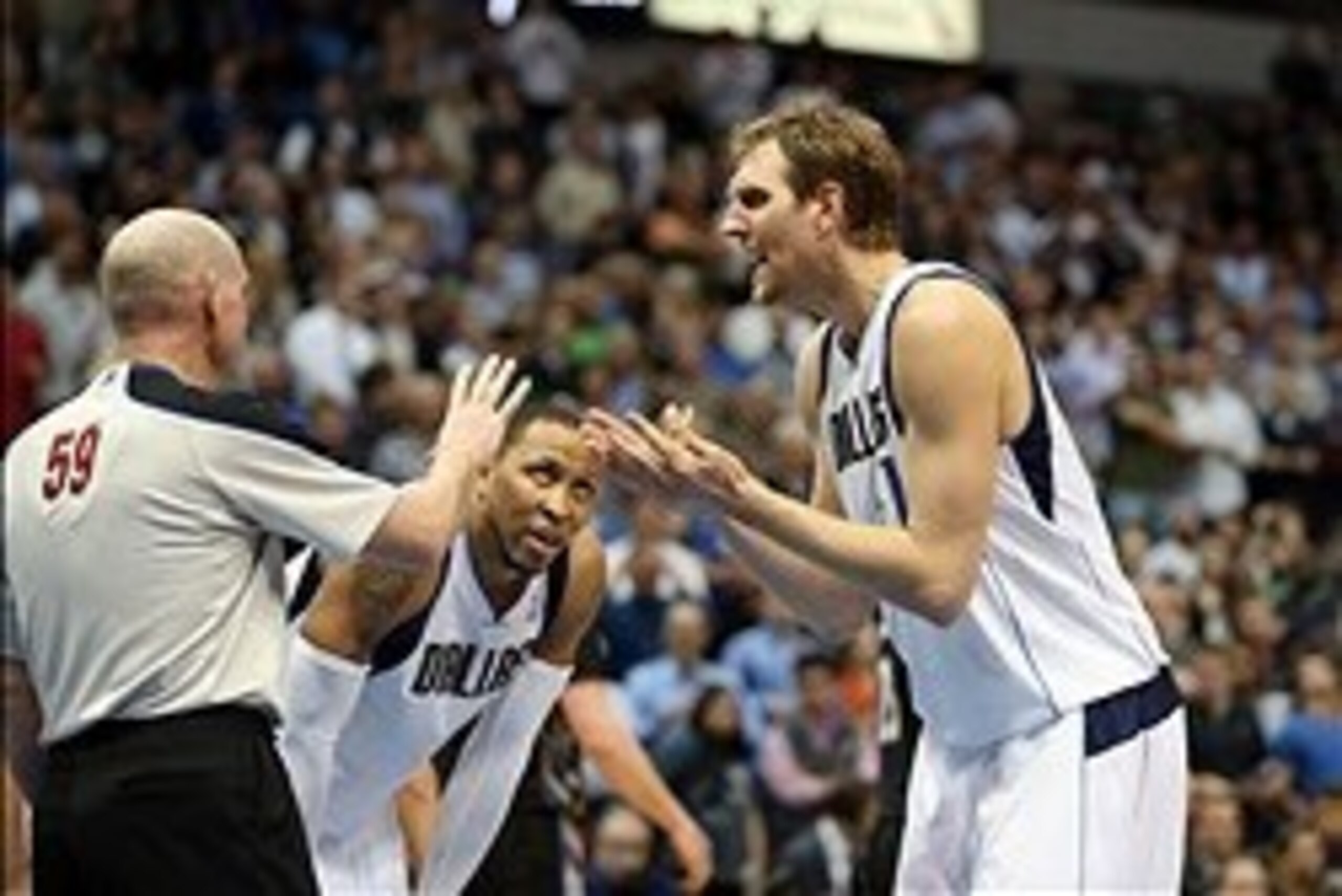 Mar 19, 2014; Dallas, TX, USA; Dallas Mavericks forward Dirk Nowitzki (41) argues a call in the fourth quarter with referee Gary Zielinski (59) against the Minnesota Timberwolves at American Airlines Center. The Timberwolves beat the Mavs 123-122 in overt