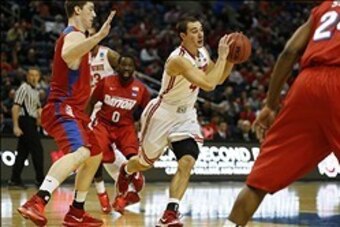 Mar 20, 2014; Buffalo, NY, USA;  Ohio State Buckeyes guard Aaron Craft (4) looks to pass against the Ohio State Buckeyes in the first half of a men's college basketball game during the second round of the 2014 NCAA Tournament at First Niagara Center. Mand