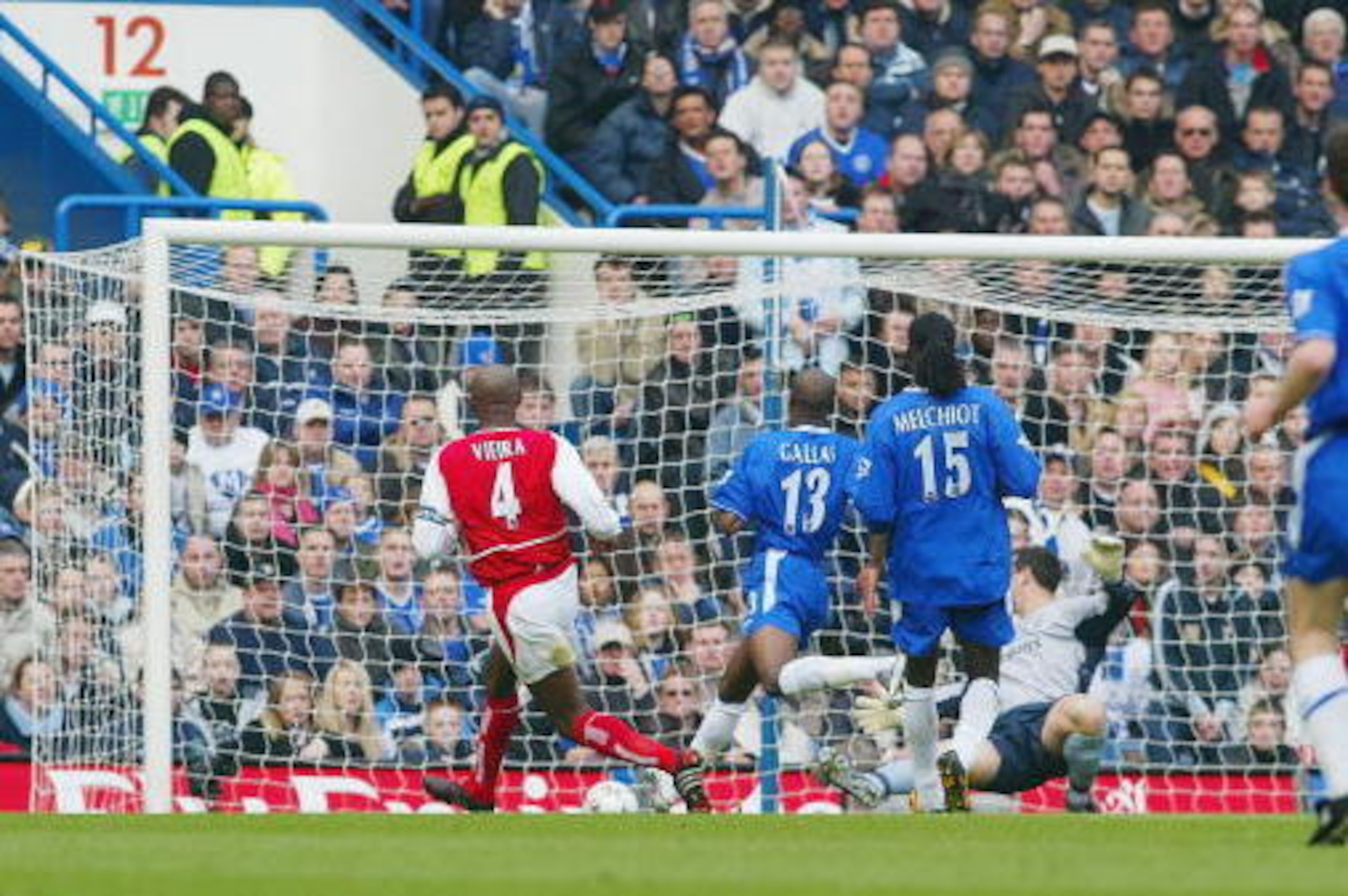 LONDON - FEBRUARY 21:  Patrick Vieira of Arsenal scores the first goal for Arsenal during the FA Barclaycard Premiership match between Chelsea and Arsenal at Stamford Bridge on February 21, 2004 in London.  (Photo by Mark Thompson/Getty Images)