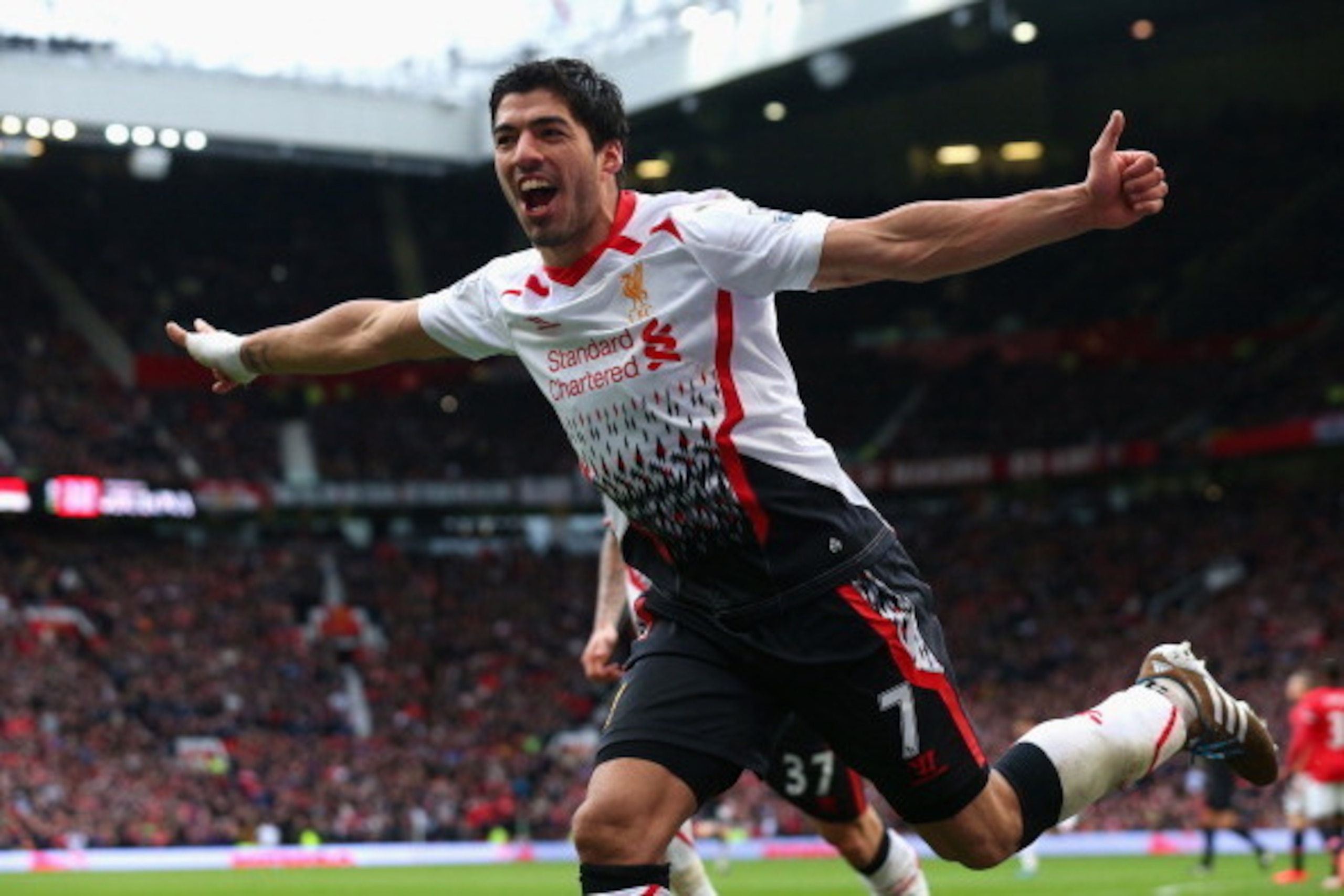 MANCHESTER, ENGLAND - MARCH 16:  Luis Suarez of Liverpool celebrates scoring his team's third goal during the Barclays Premier League match between Manchester United and Liverpool at Old Trafford on March 16, 2014 in Manchester, England.  (Photo by Alex L
