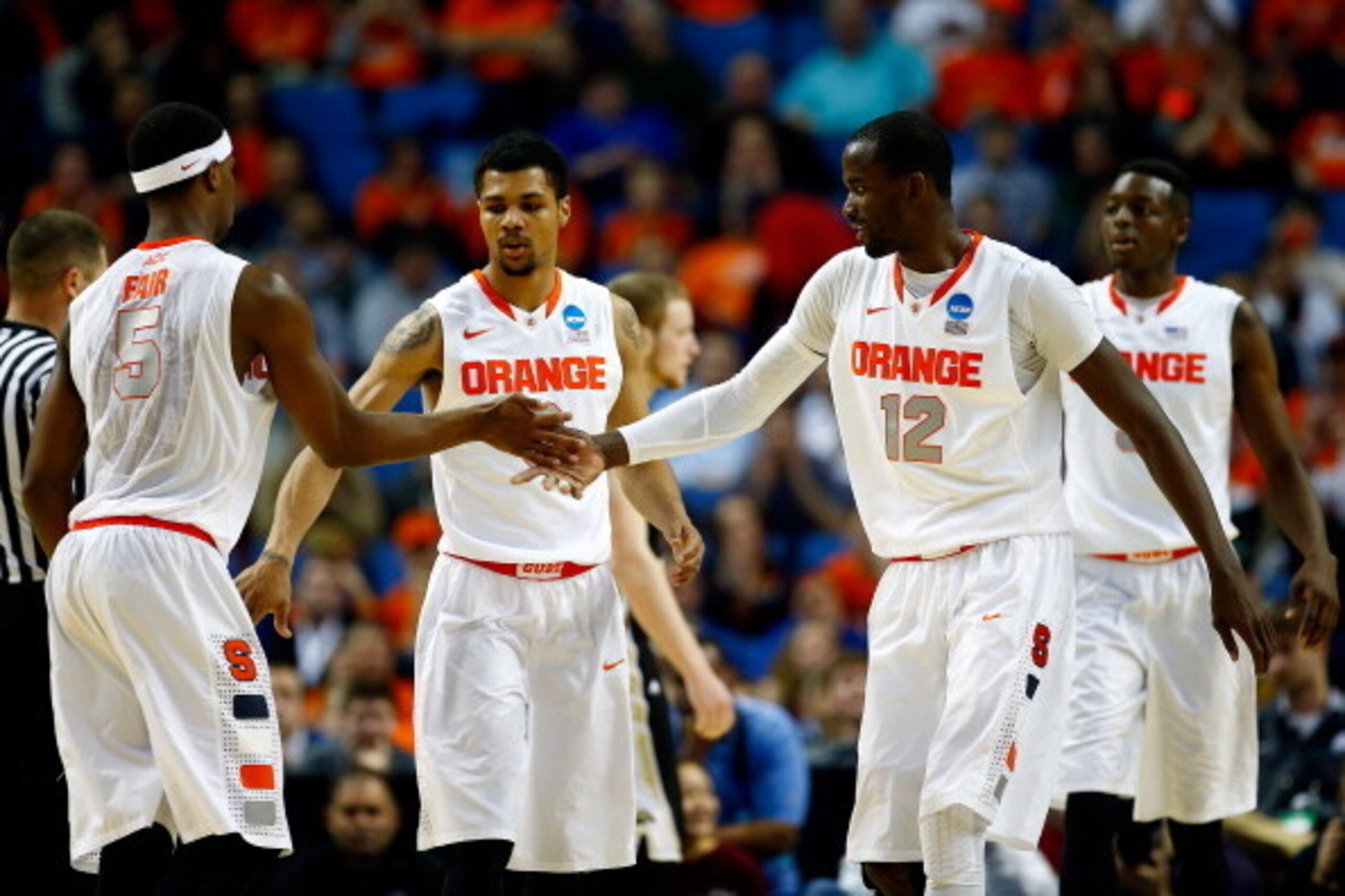BUFFALO, NY - MARCH 20: C.J. Fair #5 celebrates with Michael Gbinije #0 and Baye-Moussa Keita #12 of the Syracuse Orange against the Western Michigan Broncos during the second round of the 2014 NCAA Men's Basketball Tournament at the First Niagara Center BUFFALO, NY - MARCH 20: C.J. Fair #5 celebrates with Michael Gbinije #0 and Baye-Moussa Keita #12 of the Syracuse Orange against the Western Michigan Broncos during the second round of the 2014 NCAA Men's Basketball Tournament at the First Niagara Center