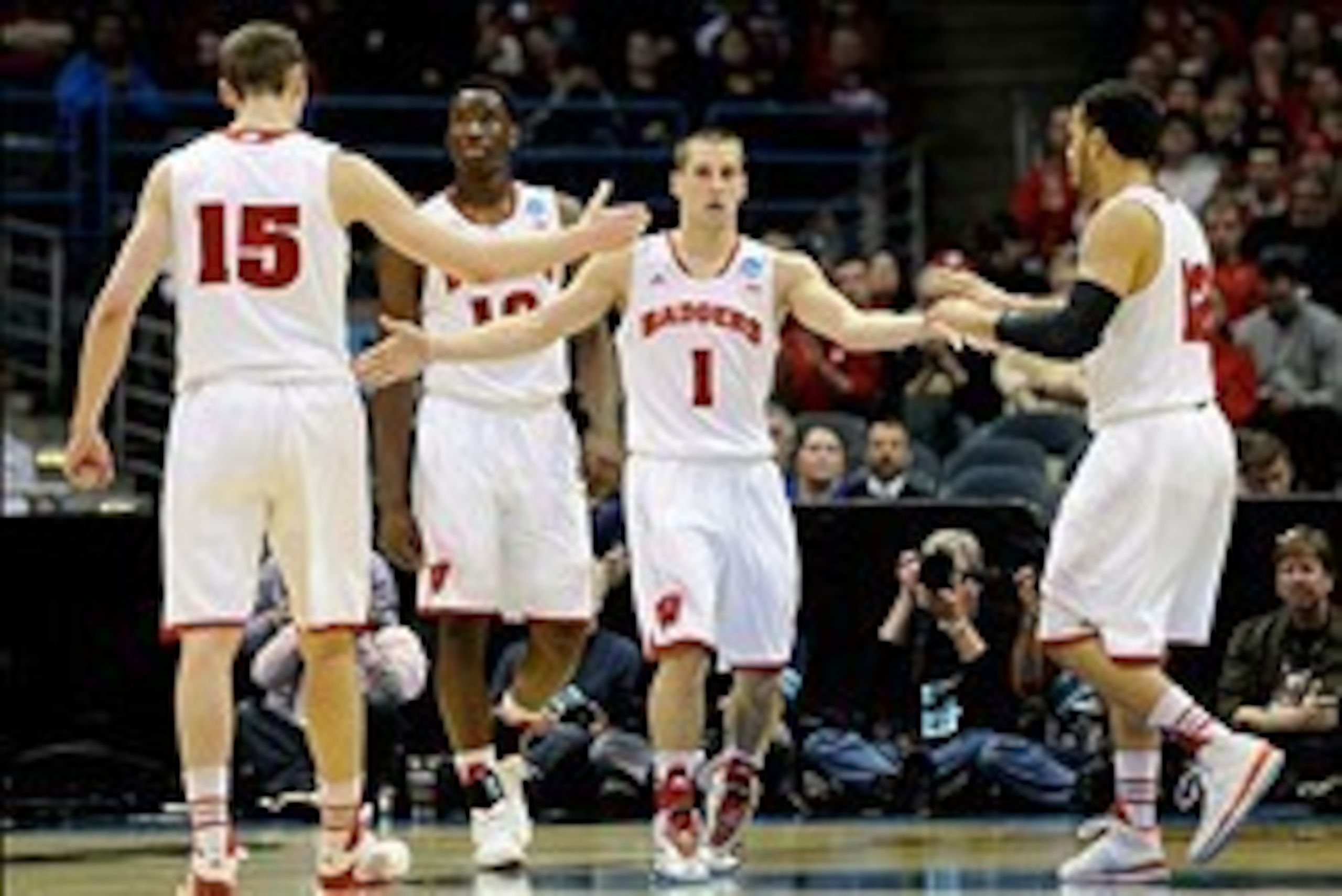 Mar 20, 2014; Milwaukee, WI, USA; Wisconsin Badgers guard Ben Brust (1) celebrates with forward Sam Dekker (15), guard Traevon Jackson (12) and forward Nigel Hayes (10) during the second round of the 2014 NCAA Tournament against the American University Ea