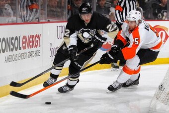 PITTSBURGH, PA - MARCH 16:  Lee Stempniak #22 of the Pittsburgh Penguins tries to get past the defense of Braydon Coburn #5 of the Philadelphia Flyers on March 16, 2014 at Consol Energy Center in Pittsburgh, Pennsylvania.  (Photo by Gregory Shamus/NHLI vi