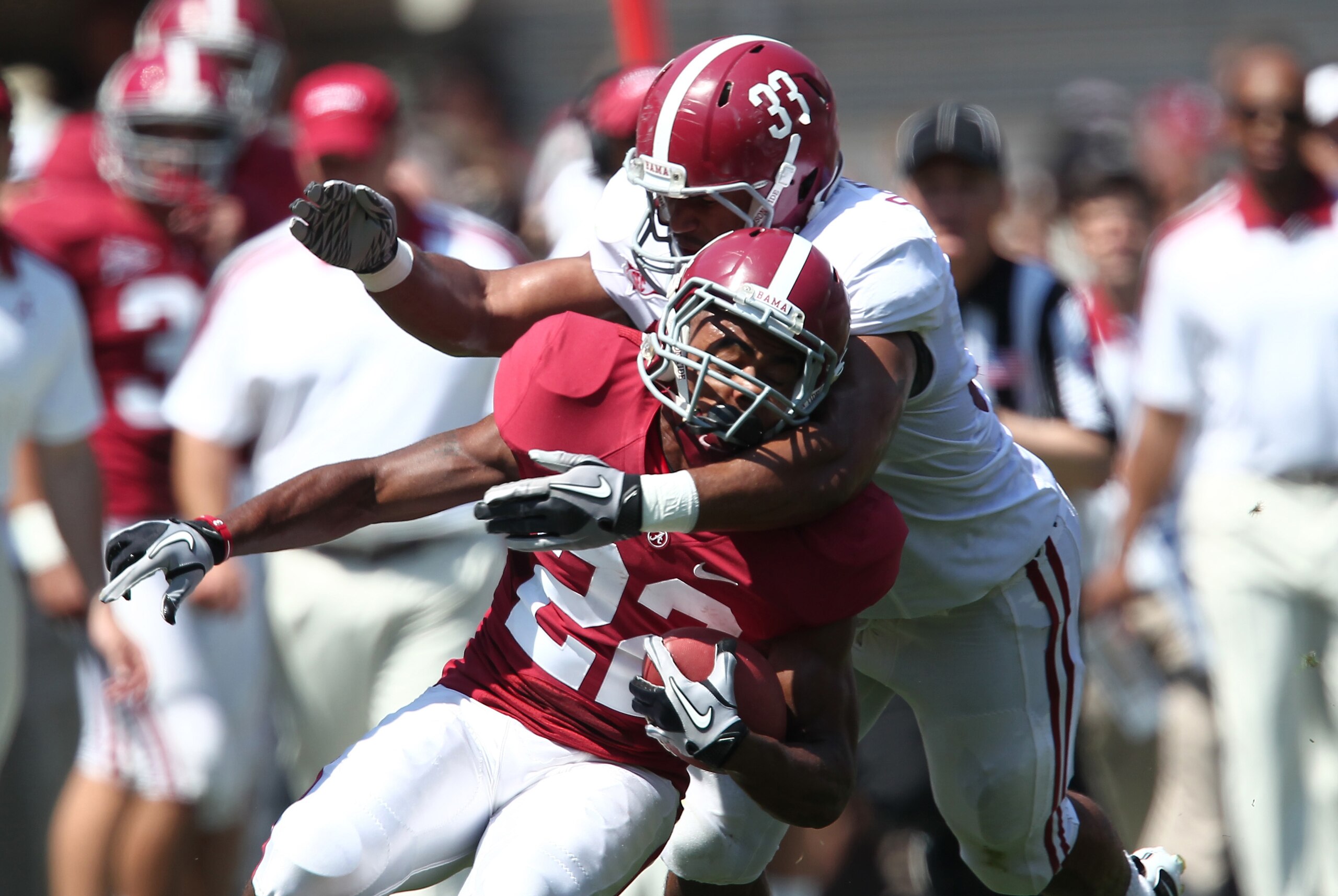 Apr 14, 2012; Tuscaloosa, AL, USA; Alabama Crimson Tide wide receiver Christion Jones (22) is tackled by  linebacker Trey Depriest (33) during the spring game  at Bryant Denny Stadium. Mandatory Credit: Marvin Gentry-USA TODAY Sports