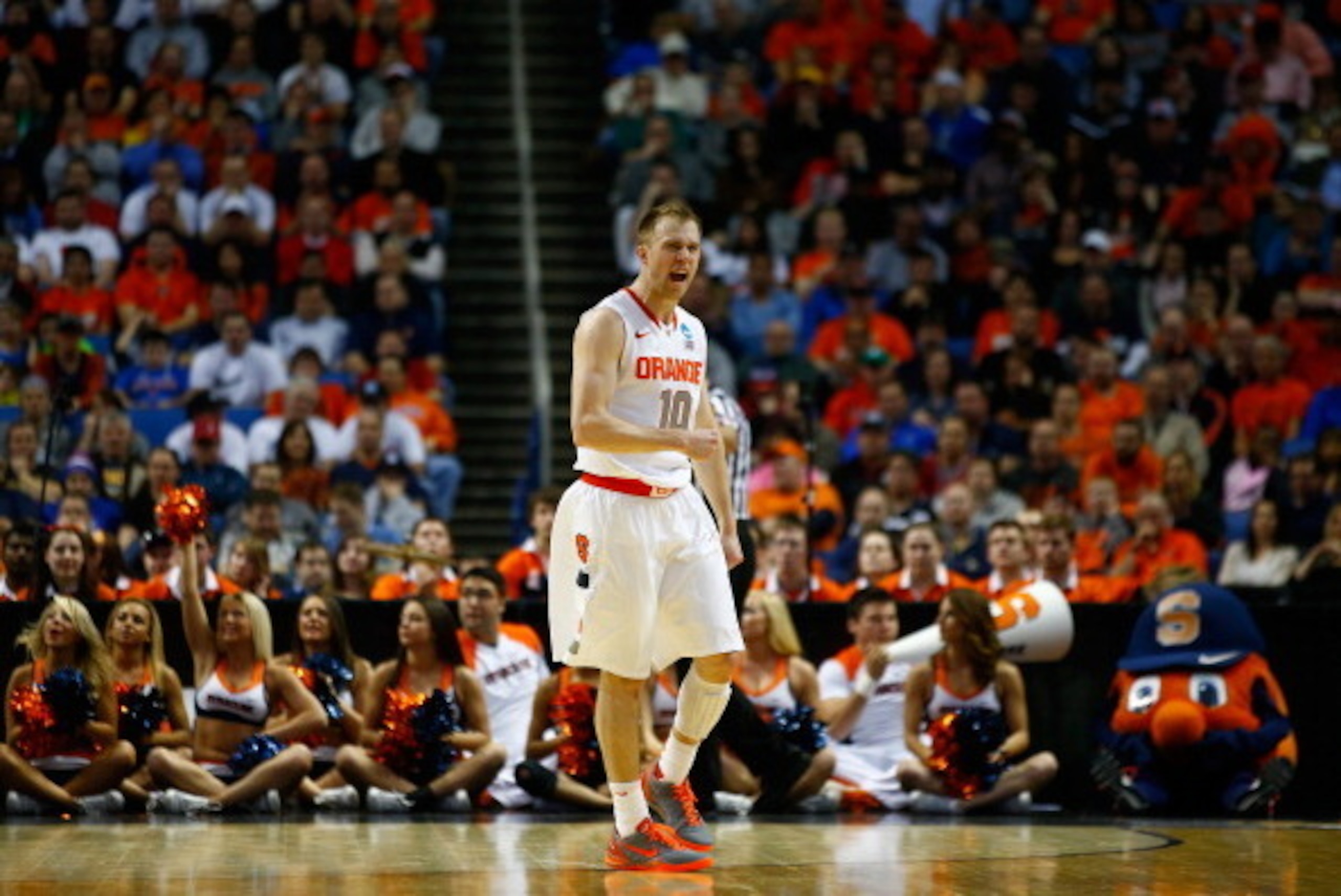 BUFFALO, NY - MARCH 20: Trevor Cooney #10 of the Syracuse Orange celebrates a turnover by the Western Michigan Broncos during the second round of the 2014 NCAA Men's Basketball Tournament at the First Niagara Center on March 20, 2014 in Buffalo, New York.