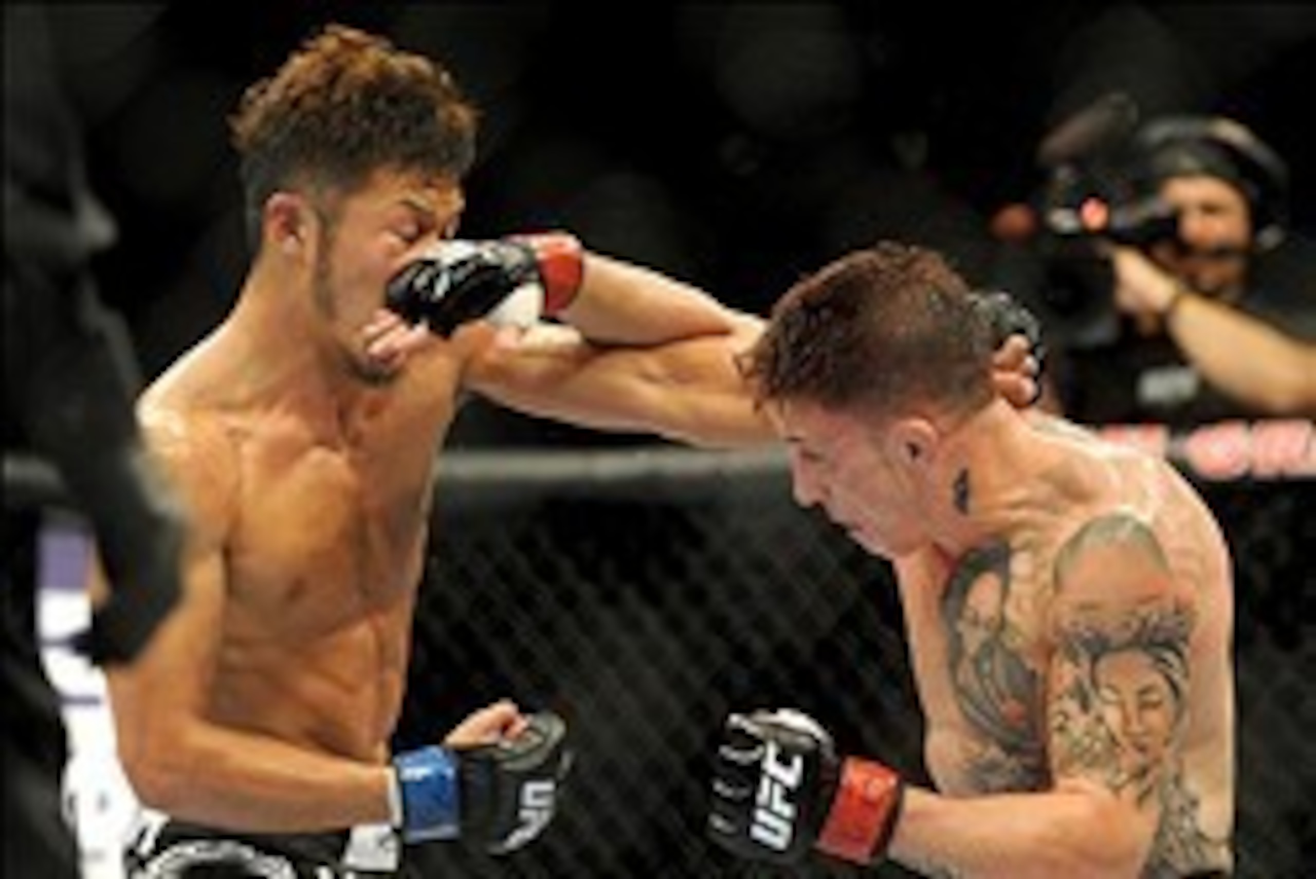 Jul 6, 2013; Las Vegas, NV, USA;  Norman Parke (red gloves) and Kazuki Tokudome (blue gloves) during their Lightweight Bout at the MGM Grand Garden Arena. Parke won.  Mandatory Credit: Jayne Kamin-Oncea-USA TODAY Sports