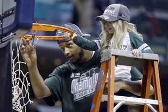 Lacey helps Payne cut down the net after the Big Ten Championship.