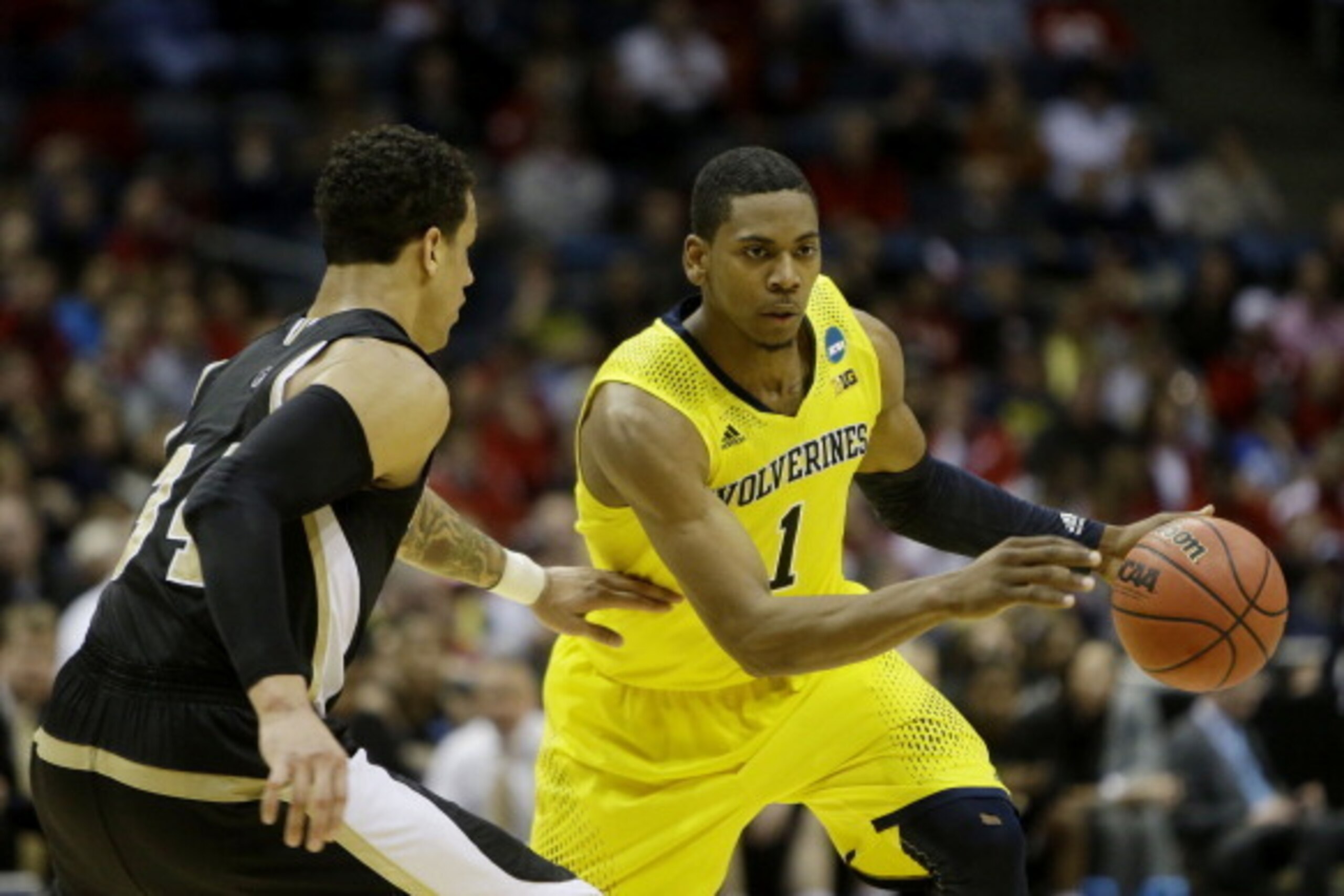 MILWAUKEE, WI - MARCH 20: Glenn Robinson III #1 of the Michigan Wolverines drives against Lee Skinner #34 of the Wofford Terriers in the second half during the second round of the 2014 NCAA Men's Basketball Tournament at BMO Harris Bradley Center on Marc MILWAUKEE, WI - MARCH 20: Glenn Robinson III #1 of the Michigan Wolverines drives against Lee Skinner #34 of the Wofford Terriers in the second half during the second round of the 2014 NCAA Men's Basketball Tournament at BMO Harris Bradley Center on Marc