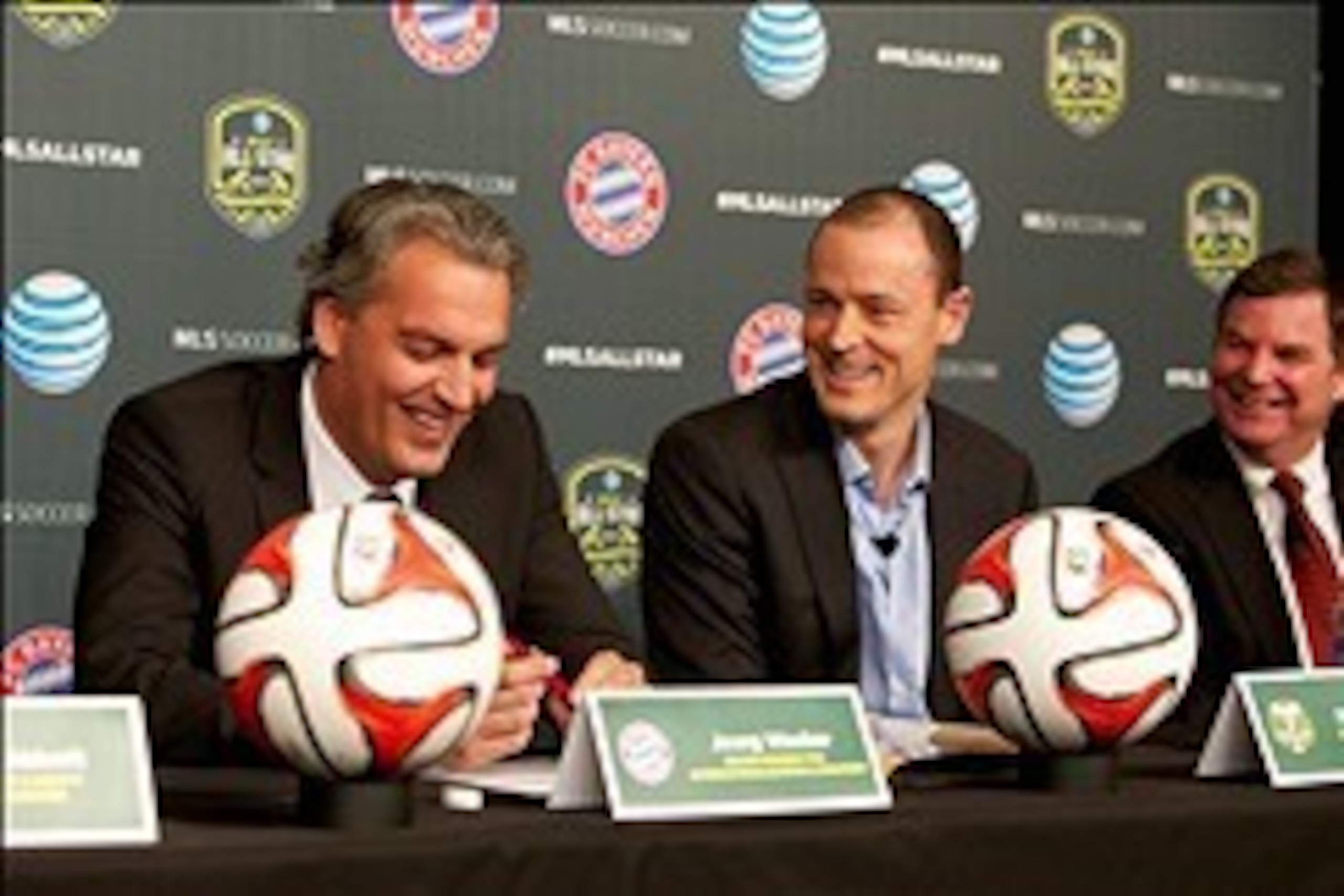 Dec 12, 2013; Portland, OR, USA; Bayern Munich board member for internationalization and strategy Joerg Wacker, and Portland Timbers owner Merritt Paulson, and AT&T Oregon president George Grander laugh during the 2014 MLS All Star Game during a press con