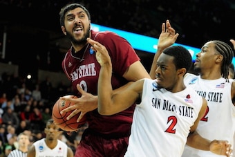 SPOKANE, WA - MARCH 20:  Sim Bhullar #2 of the New Mexico State Aggies is defended by Xavier Thames #2 and Josh Davis #22 of the San Diego State Aztecs during the second round of the 2014 NCAA Men's Basketball Tournament at Spokane Veterans Memorial Arena