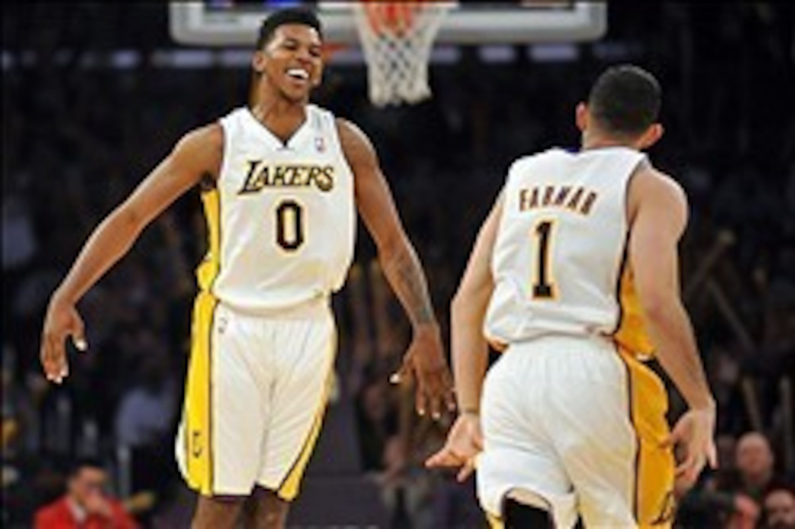 November 17, 2013; Los Angeles, CA, USA; Los Angeles Lakers small forward Nick Young (0) reacts after point guard Jordan Farmar (1) scores a three point basket against the Detroit Pistons during the second half at Staples Center. Mandatory Credit: Gary A.