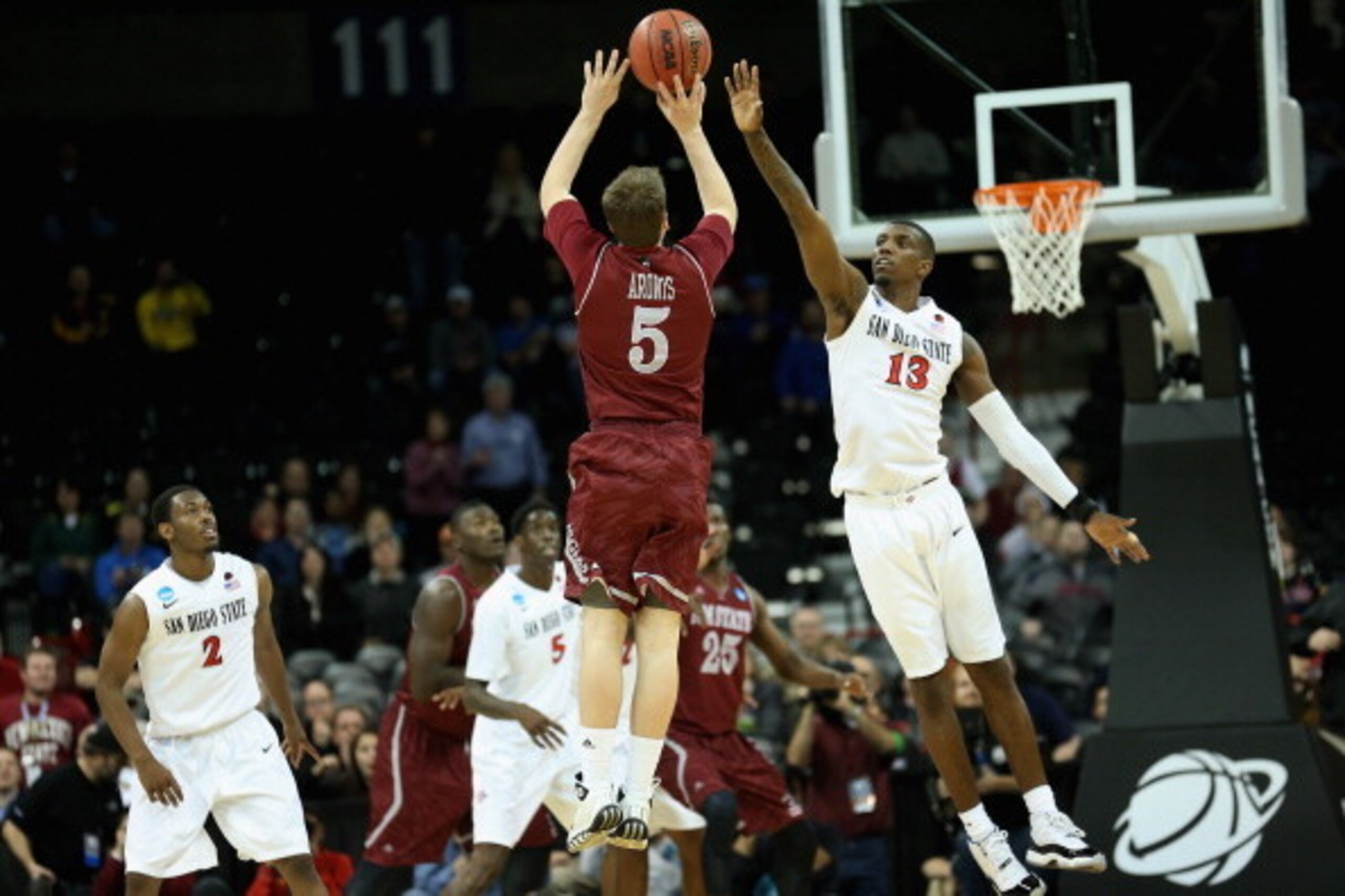 SPOKANE, WA - MARCH 20: Kevin Aronis #5 of the New Mexico State Aggies makes a three pointer over Winston Shepard #13 of the San Diego State Aztecs to tie the game and send it into overtime during the second round of the 2014 NCAA Men's Basketball Tourna SPOKANE, WA - MARCH 20: Kevin Aronis #5 of the New Mexico State Aggies makes a three pointer over Winston Shepard #13 of the San Diego State Aztecs to tie the game and send it into overtime during the second round of the 2014 NCAA Men's Basketball Tourna