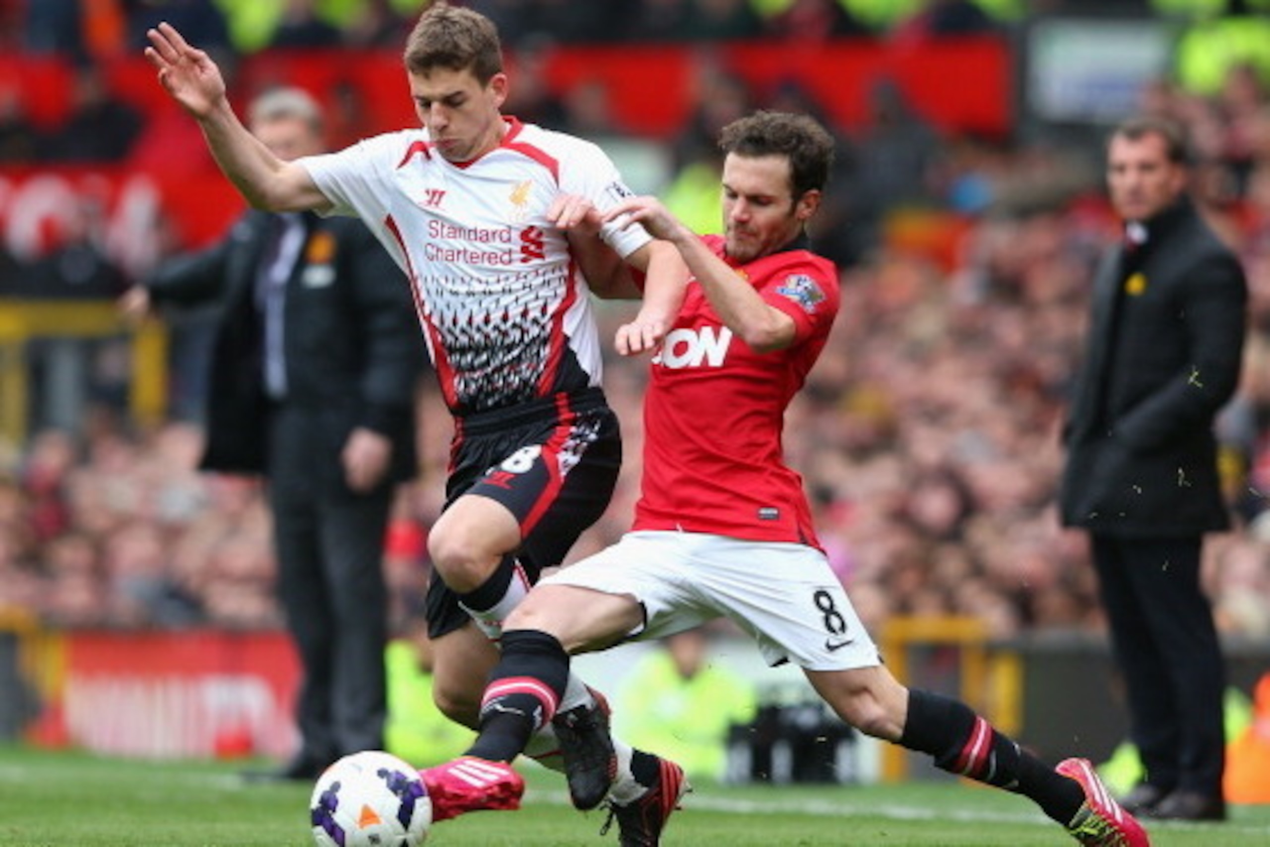 MANCHESTER, ENGLAND - MARCH 16:  Jon Flanagan of Liverpool competes with Juan Mata of Manchester United during the Barclays Premier League match between Manchester United and Liverpool at Old Trafford on March 16, 2014 in Manchester, England.  (Photo by A