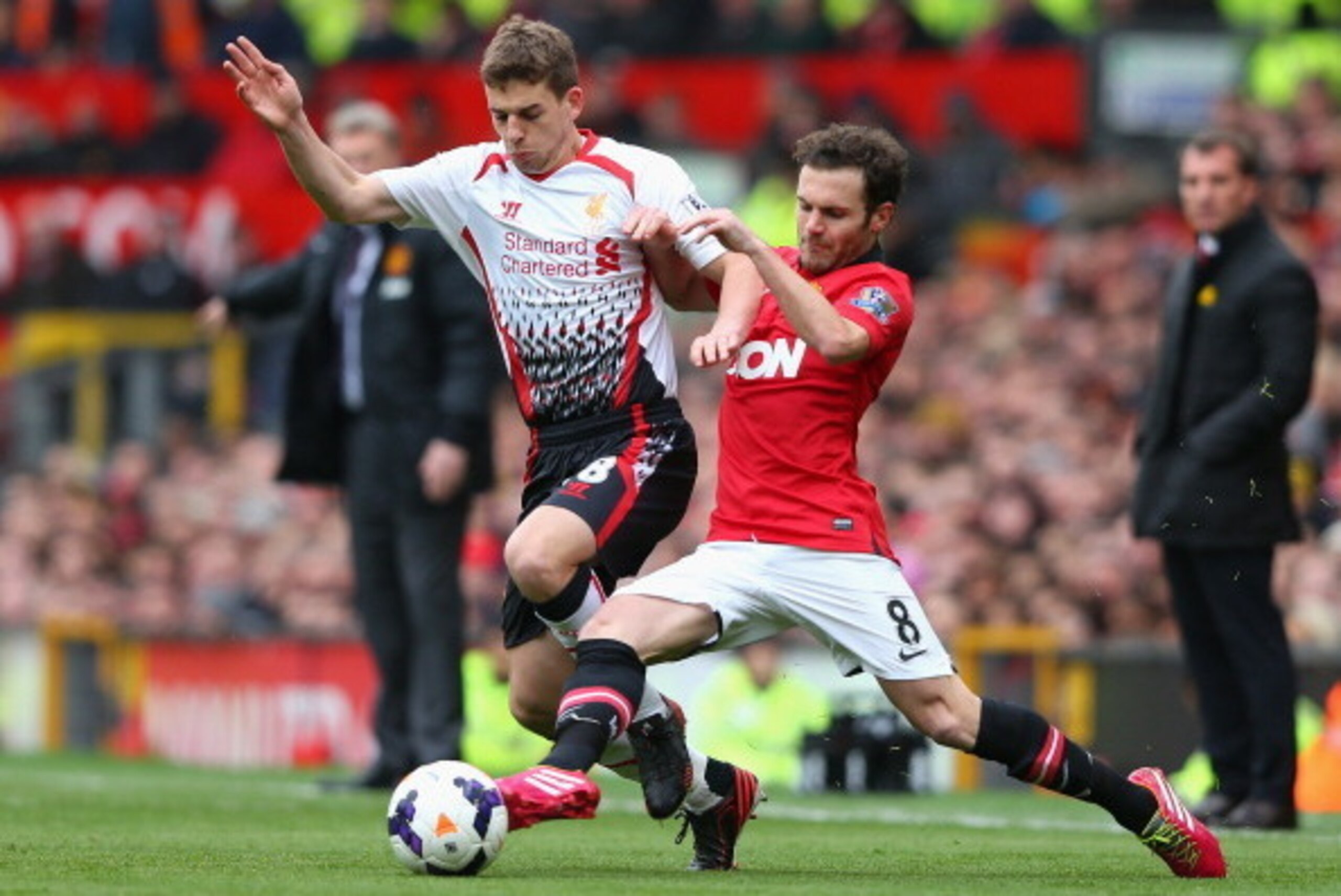 MANCHESTER, ENGLAND - MARCH 16:  Jon Flanagan of Liverpool competes with Juan Mata of Manchester United during the Barclays Premier League match between Manchester United and Liverpool at Old Trafford on March 16, 2014 in Manchester, England.  (Photo by A