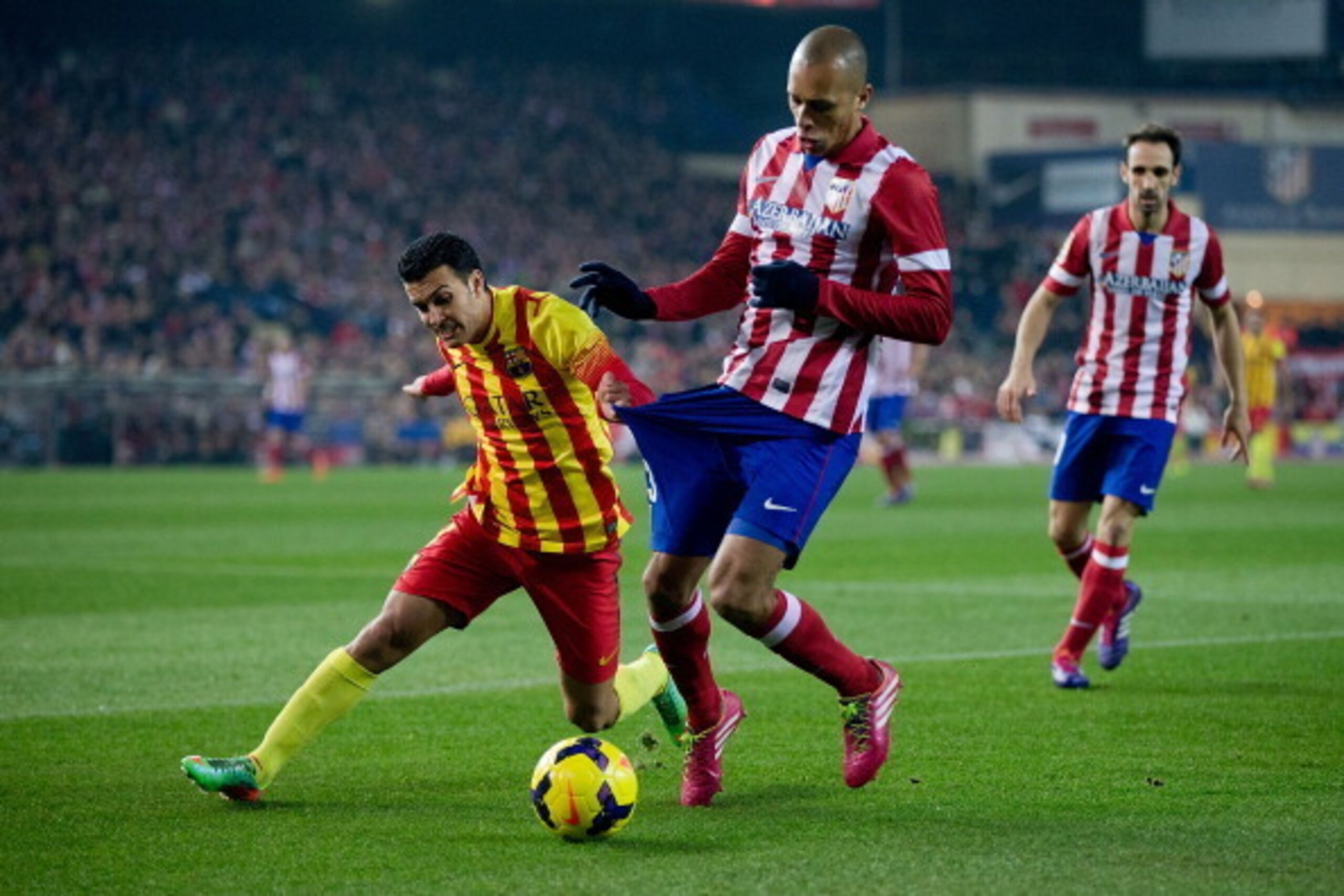 MADRID, SPAIN - JANUARY 11:  Pedro Rodriguez Ledesma (L) of FC Barcelona competes for the ball with Joao Miranda (R) of Atletico de Madrid during the La Liga match between Club Atletico de Madrid and FC Barcelona at Vicente Calderon Stadium on January 11,