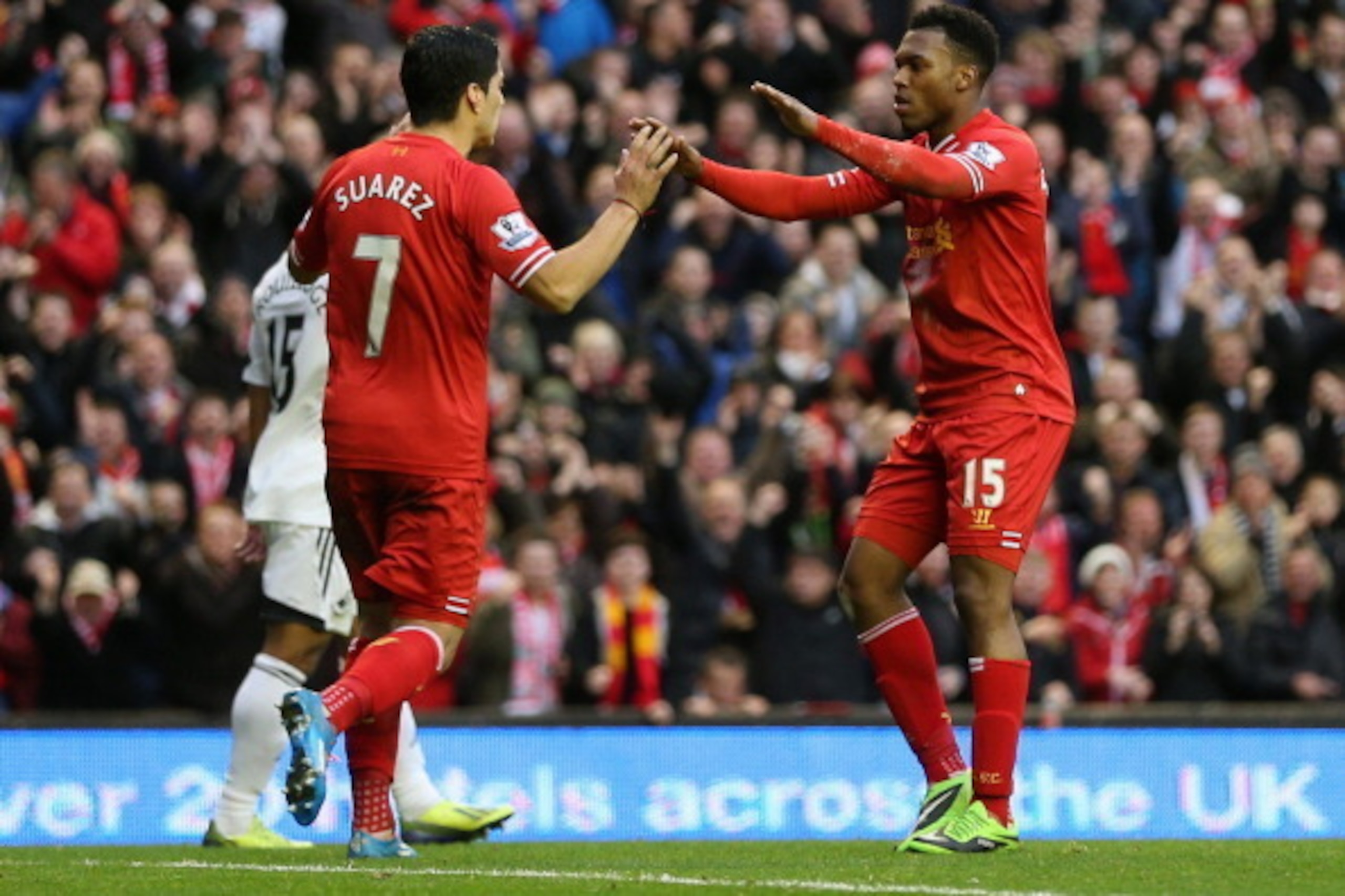 LIVERPOOL, ENGLAND - FEBRUARY 23:  Daniel Sturridge of Liverpool celebrates scoring his team's third goal with Luis Suarez during the Barclays Premier League match between Liverpool and Swansea City at Anfield on February 23, 2014 in Liverpool, England.  