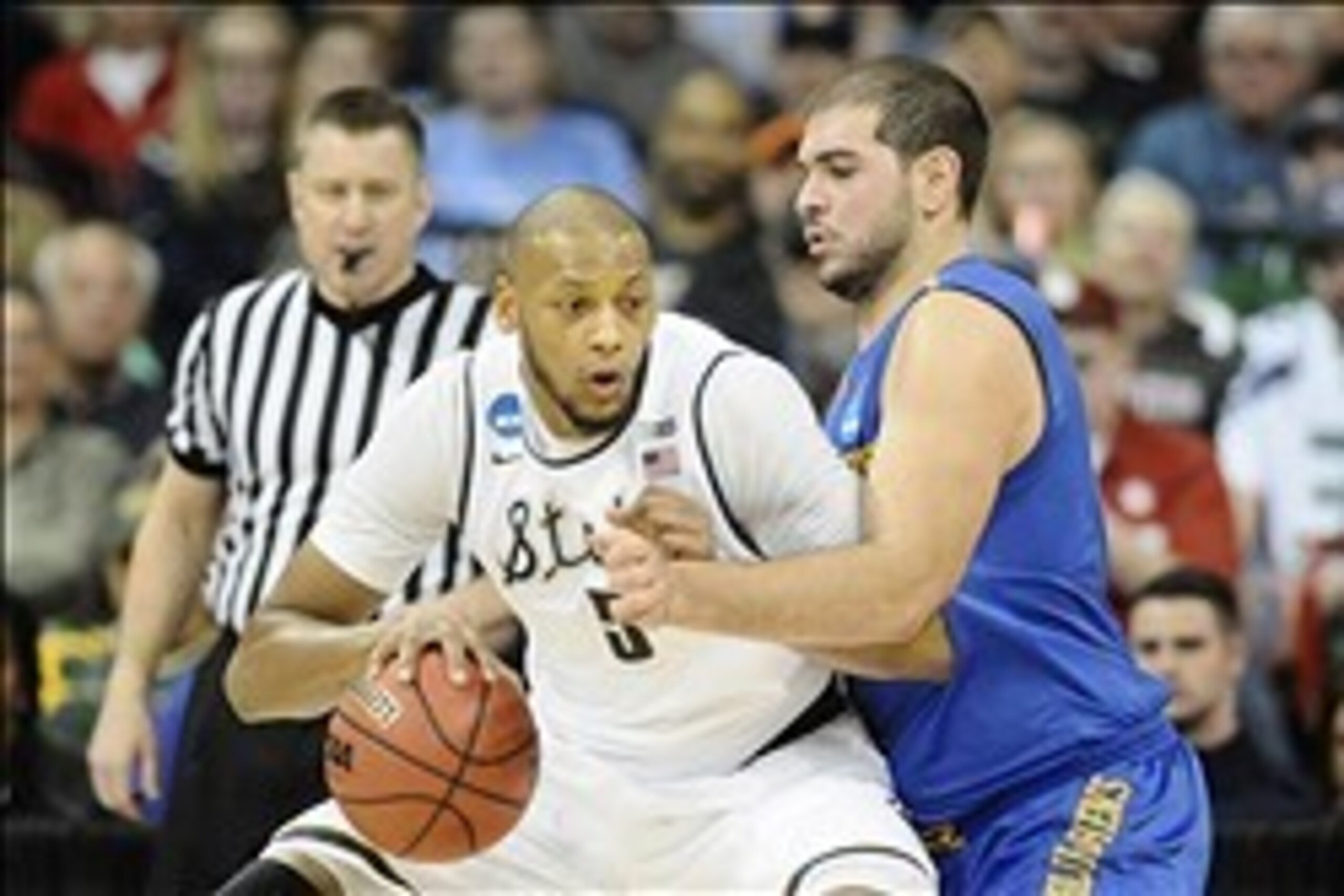 Mar 20, 2014; Spokane, WA, USA; Michigan State Spartans forward Adreian Payne (5) dribbles against Delaware Fightin Blue Hens forward Carl Baptiste (33) in the first half of a men's college basketball game during the second round of the 2014 NCAA Tourname Mar 20, 2014; Spokane, WA, USA; Michigan State Spartans forward Adreian Payne (5) dribbles against Delaware Fightin Blue Hens forward Carl Baptiste (33) in the first half of a men's college basketball game during the second round of the 2014 NCAA Tourname