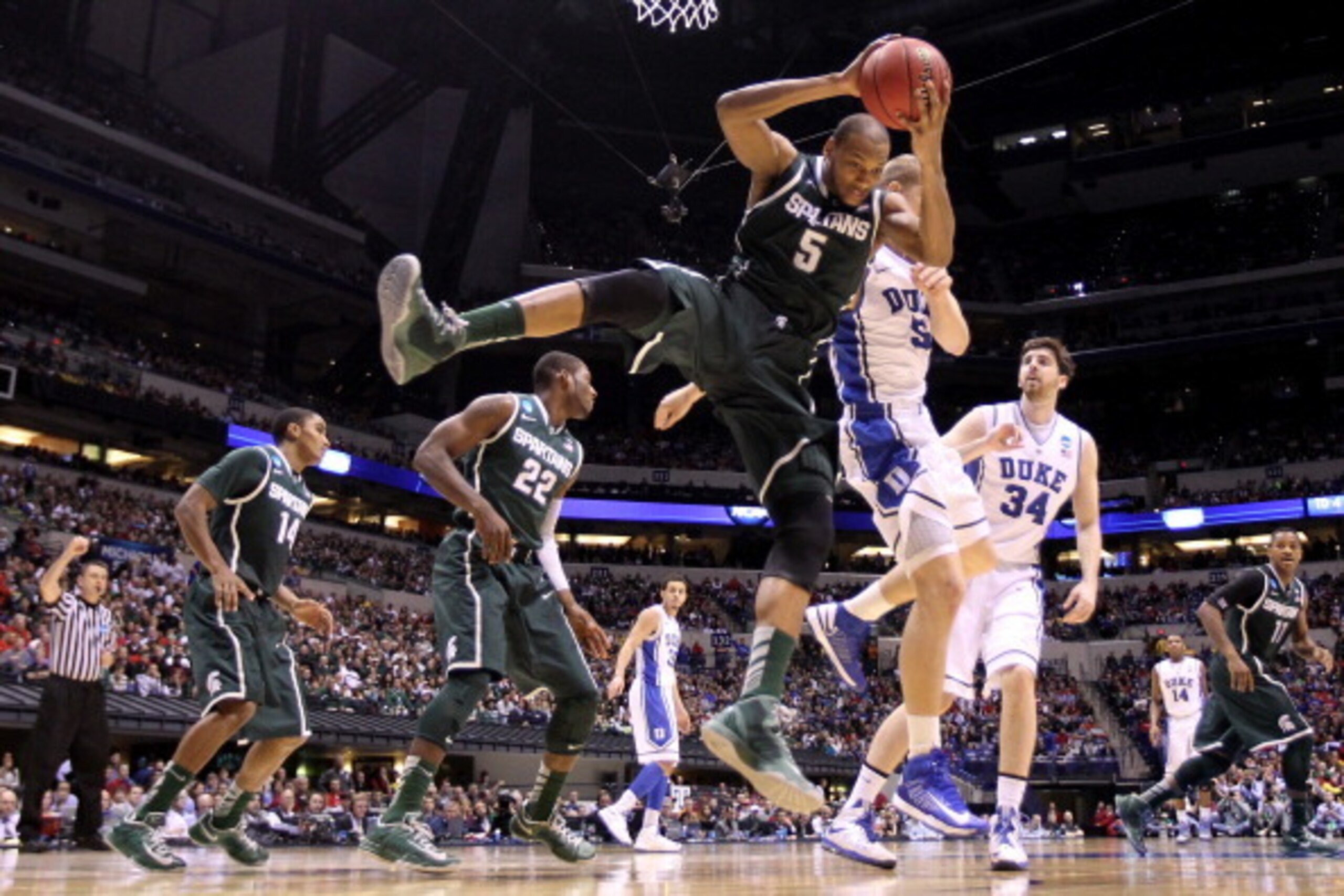 INDIANAPOLIS, IN - MARCH 29: Adreian Payne #5 of the Michigan State Spartans grabs a rebound against the Duke Blue Devils during the Midwest Region Semifinal round of the 2013 NCAA Men's Basketball Tournament at Lucas Oil Stadium on March 29, 2013 in Ind INDIANAPOLIS, IN - MARCH 29: Adreian Payne #5 of the Michigan State Spartans grabs a rebound against the Duke Blue Devils during the Midwest Region Semifinal round of the 2013 NCAA Men's Basketball Tournament at Lucas Oil Stadium on March 29, 2013 in Ind