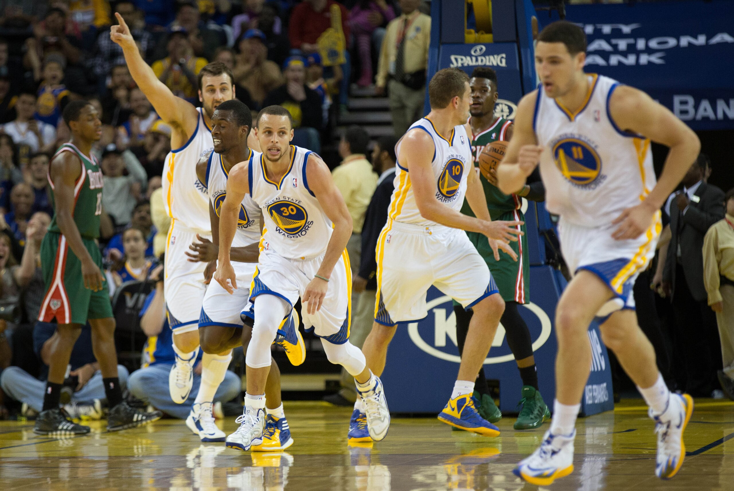 Mar 20, 2014; Oakland, CA, USA; Golden State Warriors guard Stephen Curry (30) and teammates return to defense after Curry's basket against the Milwaukee Bucks during the second quarter at Oracle Arena. Mandatory Credit: Kelley L Cox-USA TODAY Sports