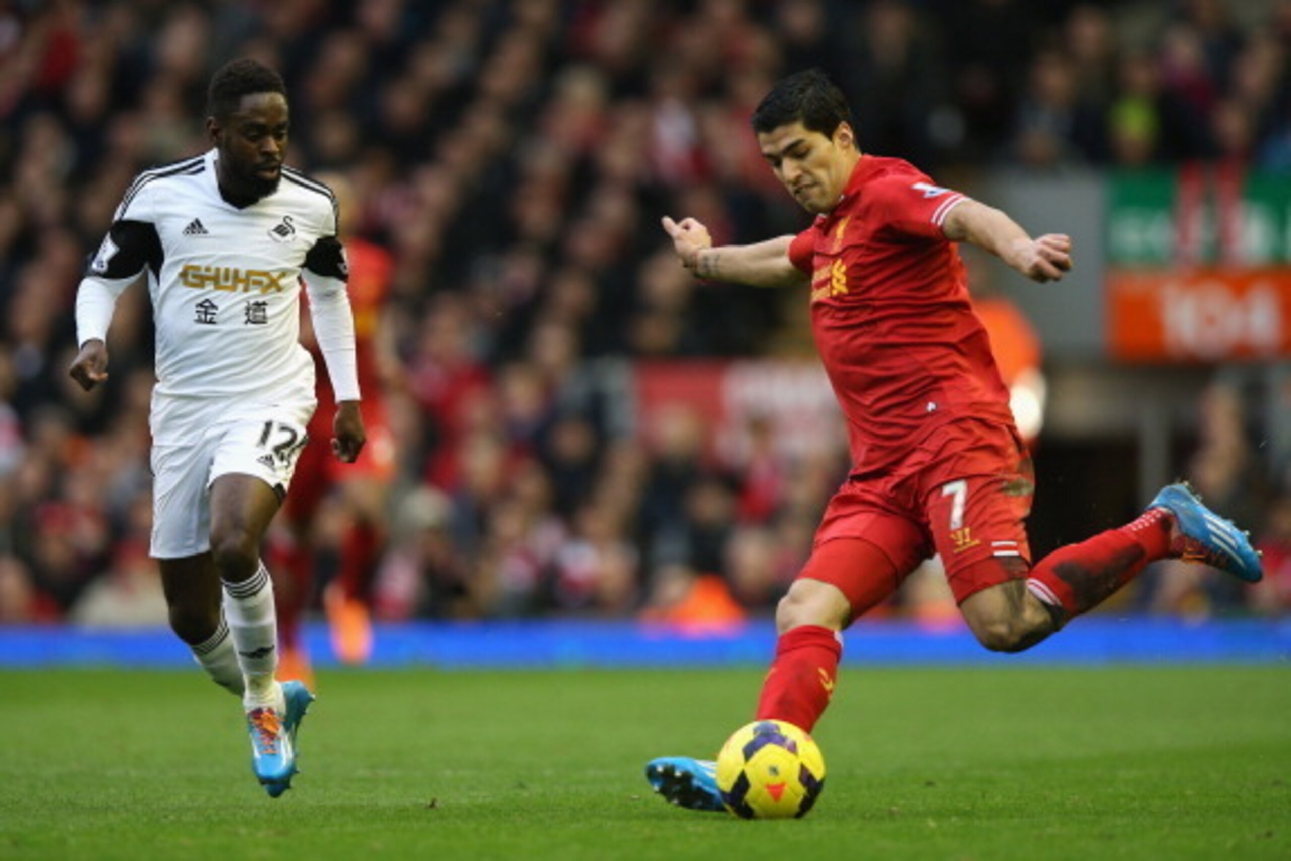 LIVERPOOL, ENGLAND - FEBRUARY 23:  Luis Suarez of Liverpool competes with Nathan Dyer of Swansea City during the Barclays Premier League match between Liverpool and Swansea City at Anfield on February 23, 2014 in Liverpool, England.  (Photo by Clive Bruns