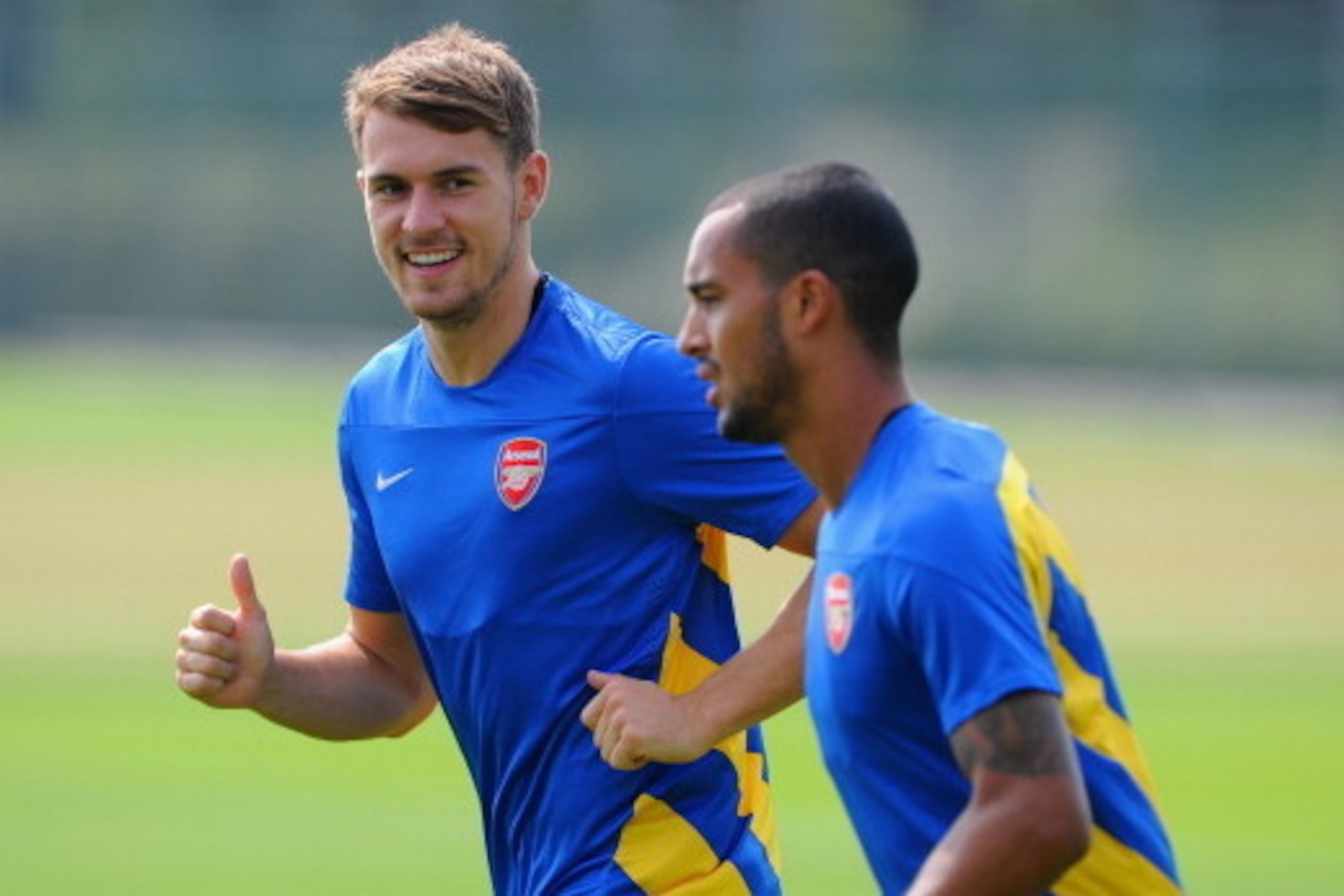 ST ALBANS, ENGLAND - AUGUST 26: Aaron Ramsey and Theo Walcott of Arsenal warm up during a training session ahead of their UEFA Champions League Play Off second leg match against Fenerbache at London Colney on August 26, 2013 in St Albans, England.  (Photo