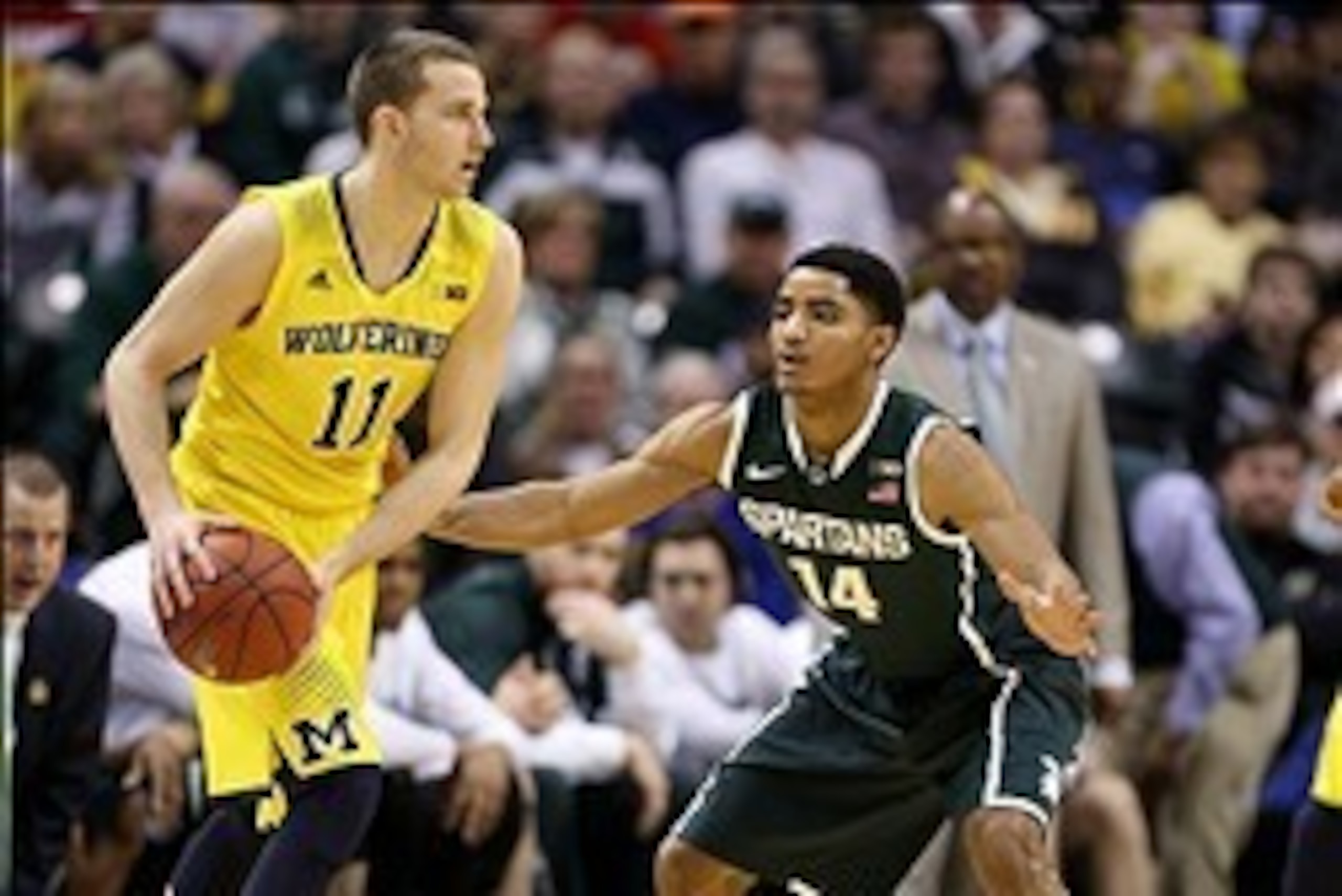 Mar 16, 2014; Indianapolis, IN, USA; Michigan Wolverines guard Nik Stauskas (11) is guarded by Michigan State Spartans guard Gary Harris (14) in the championship game for the Big Ten college basketball tournament at Bankers Life Fieldhouse. Mandatory Cred