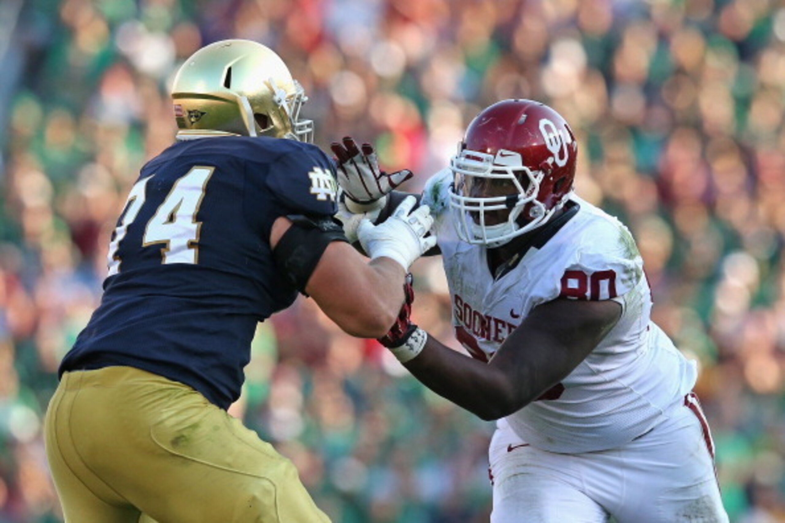 SOUTH BEND, IN - SEPTEMBER 28:  Jordan Phillips #80 of the Oklahoma Sooners rushes against Christian Lombard #74 of the Notre Dame Fighting Irish at Notre Dame Stadium on September 28, 2013 in South Bend, Indiana. Oklahoma defeated Notre Dame 35-21.  (Pho