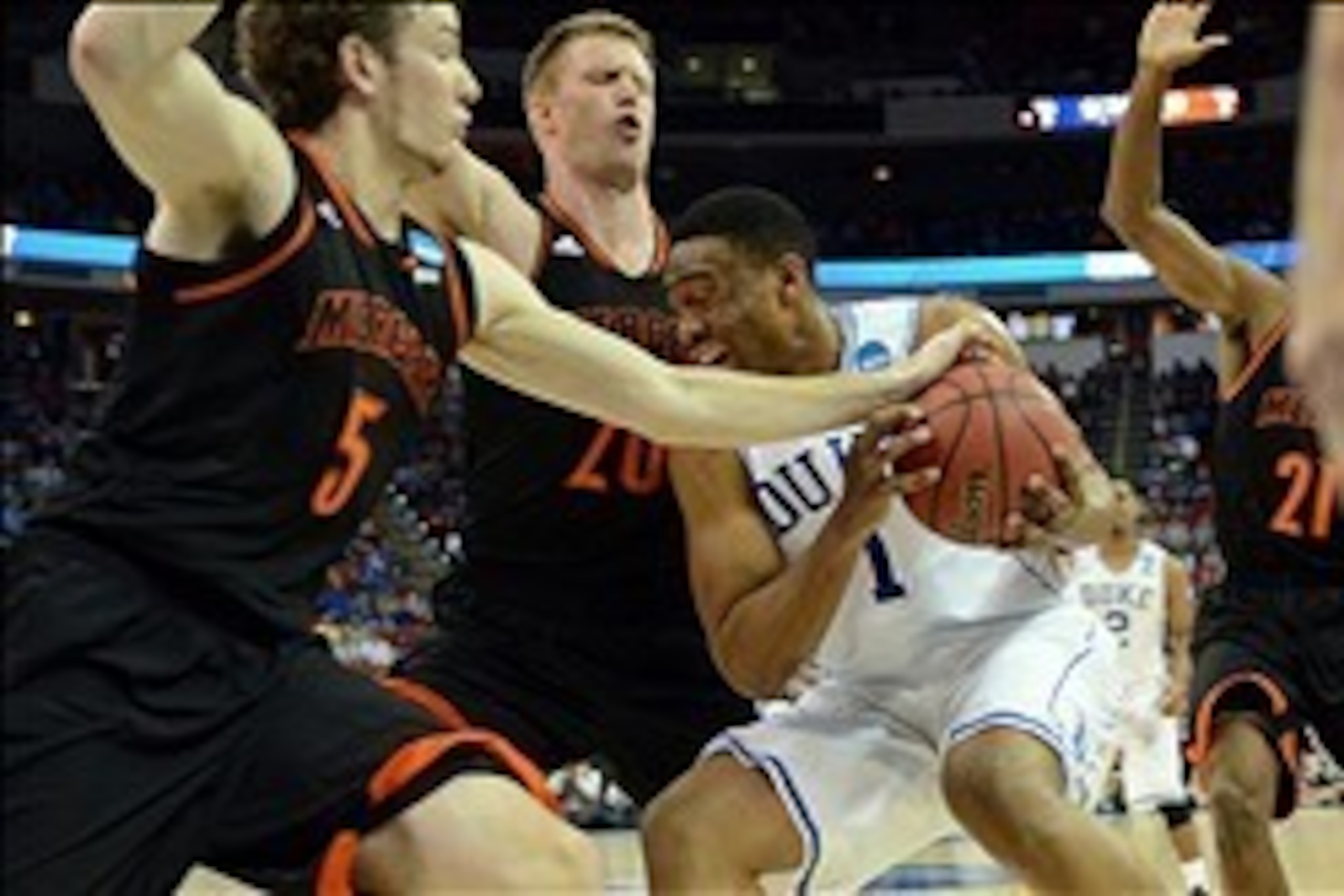 Mar 21, 2014; Raleigh, NC, USA; Duke Blue Devils forward Jabari Parker (1) drives to the basket against Mercer Bears forward Bud Thomas (5) and forward Jakob Gollon (20) in the first half of a men's college basketball game during the second round of the 2