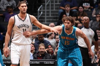 BROOKLYN, NY - MARCH 12: Brook Lopez #11 of the Brooklyn Nets positions himself against twin brother Robin Lopez #15 of the New Orleans Hornets on March 12, 2013 at the Barclays Center in the Brooklyn borough of New York City.  NOTE TO USER: User expressl