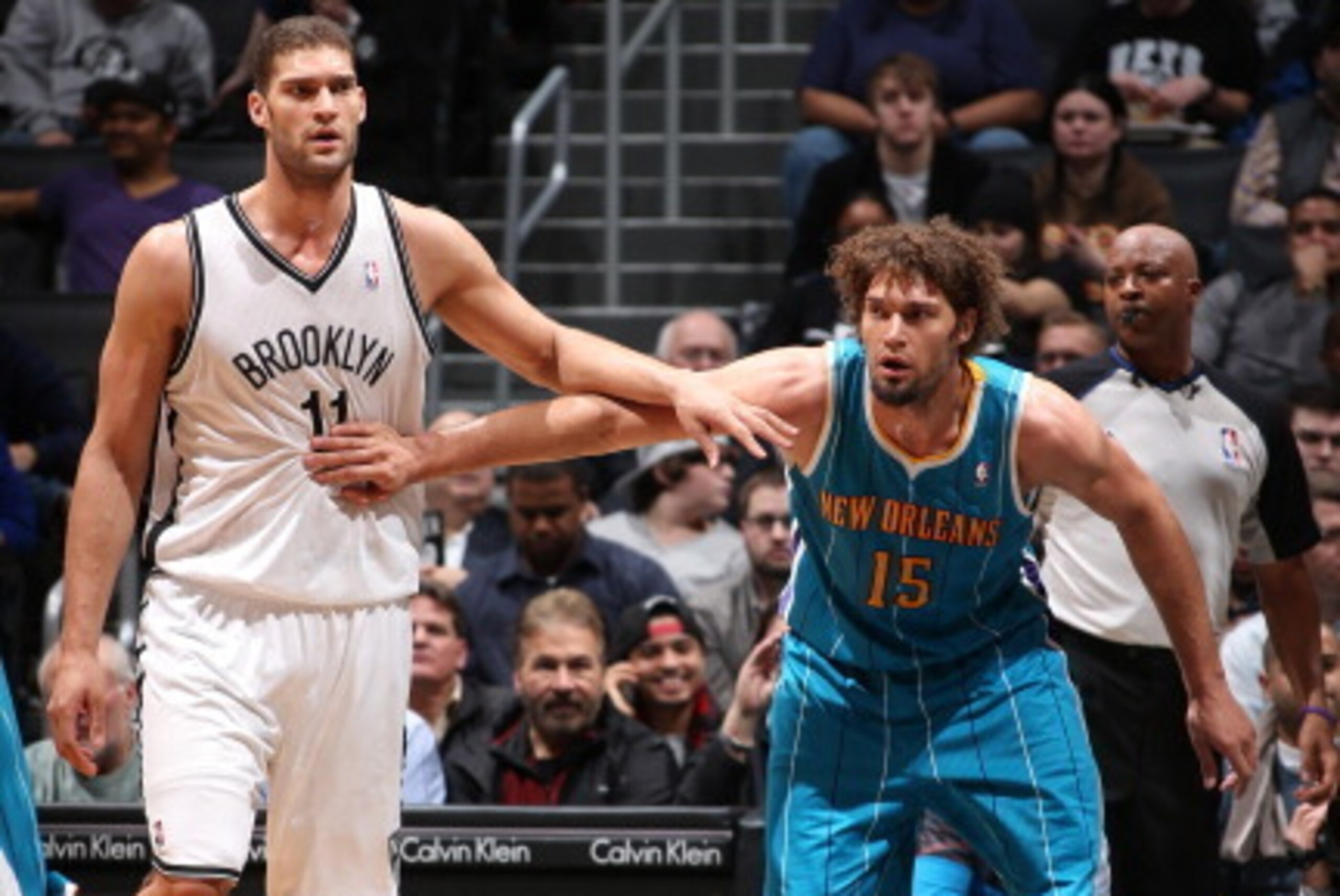 BROOKLYN, NY - MARCH 12: Brook Lopez #11 of the Brooklyn Nets positions himself against twin brother Robin Lopez #15 of the New Orleans Hornets on March 12, 2013 at the Barclays Center in the Brooklyn borough of New York City.  NOTE TO USER: User expressl